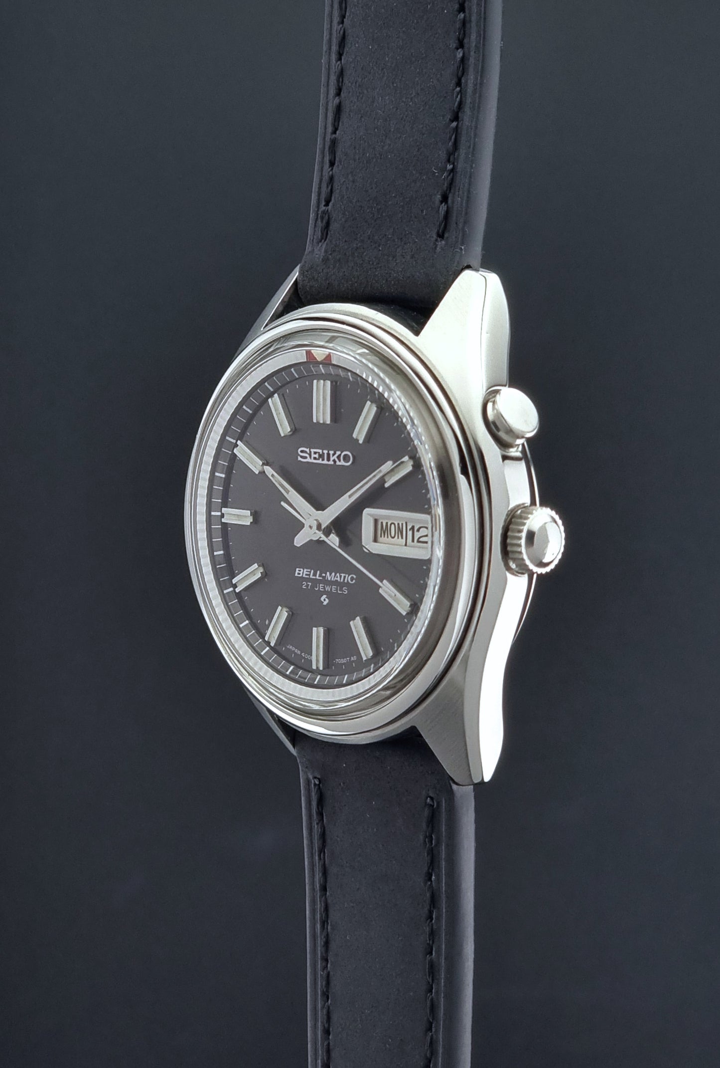 Vintage Seiko Bell-Matic watch with black leather strap on a dark background
