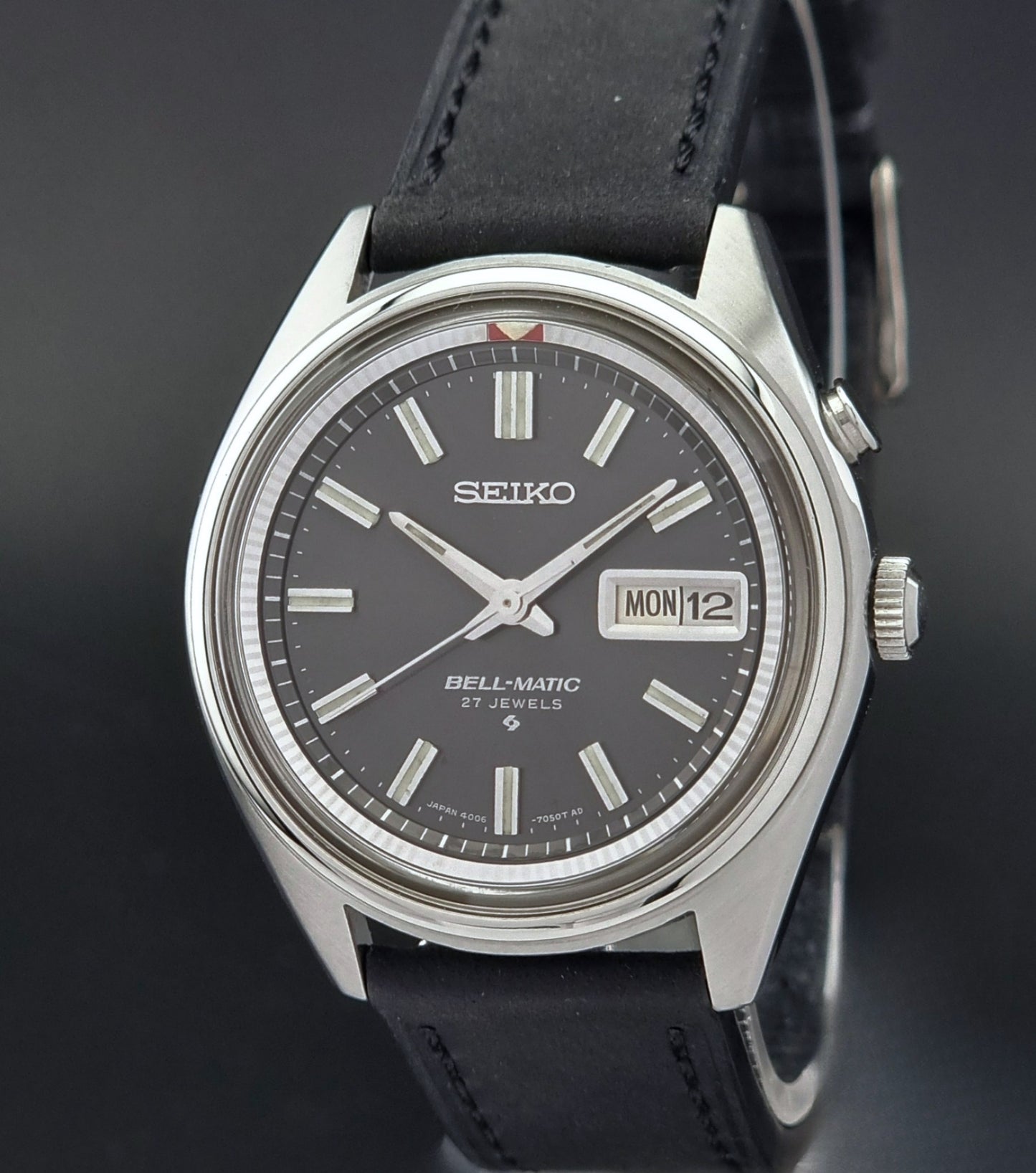 Vintage Seiko Bell-Matic watch with black leather strap on a dark background