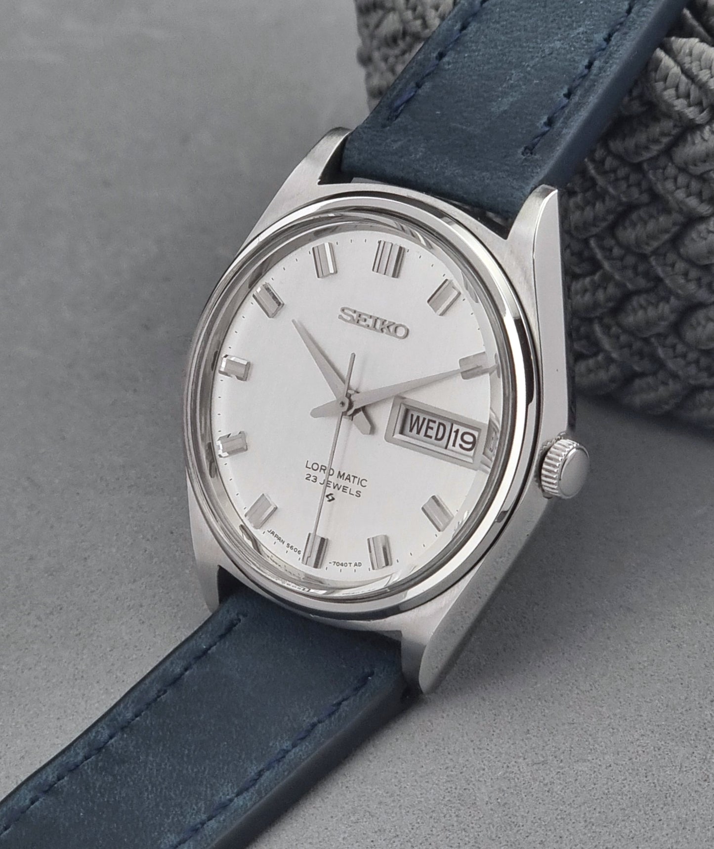 Vintage Seiko watch with blue strap on a gray background