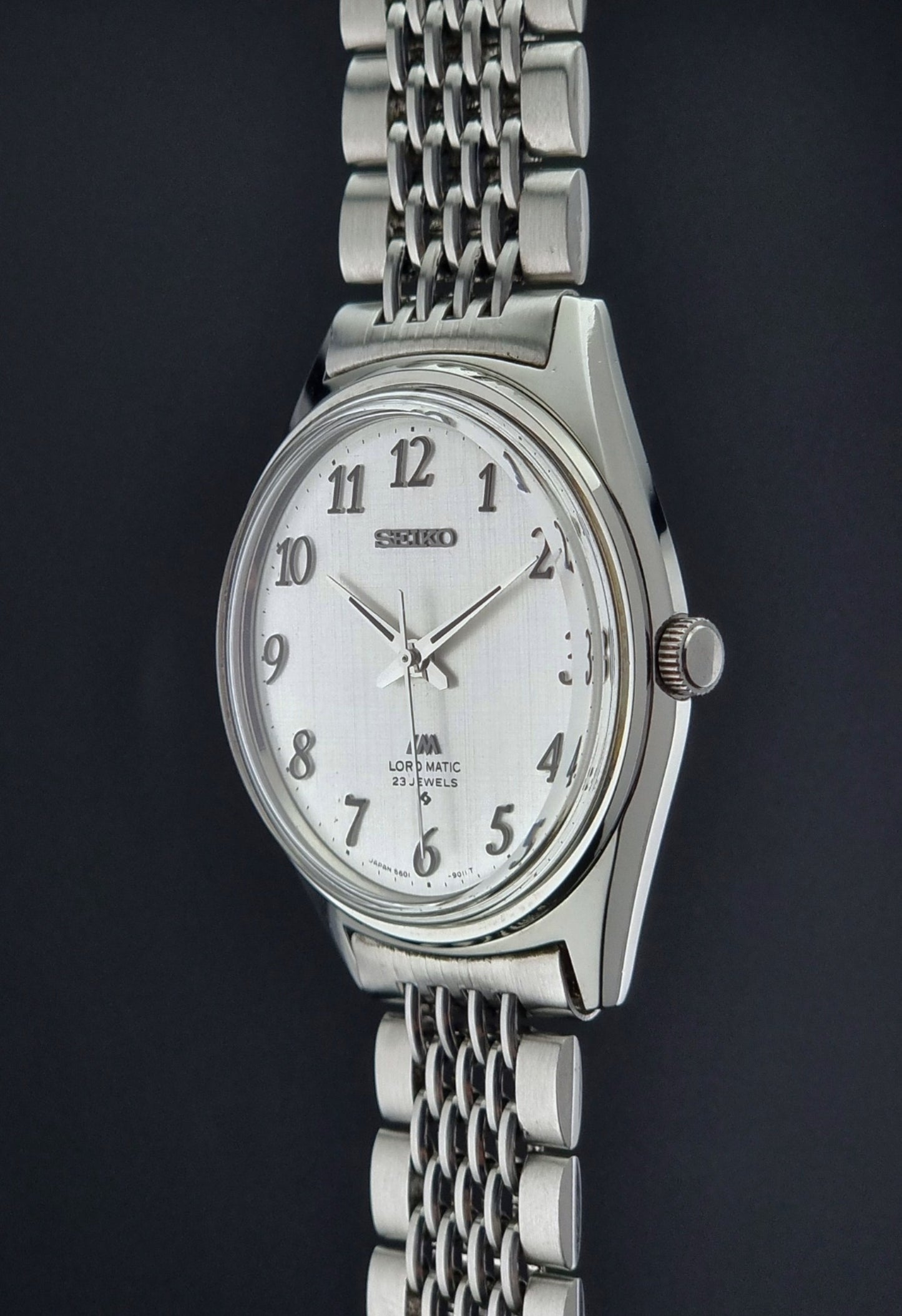 Silver Seiko Lord Matic watch with a white face on a dark background