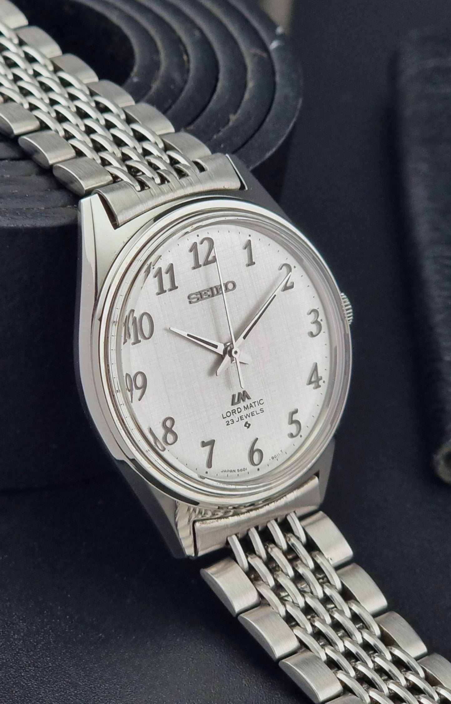 Seiko Lord Matic watch with a chain strap on a dark background