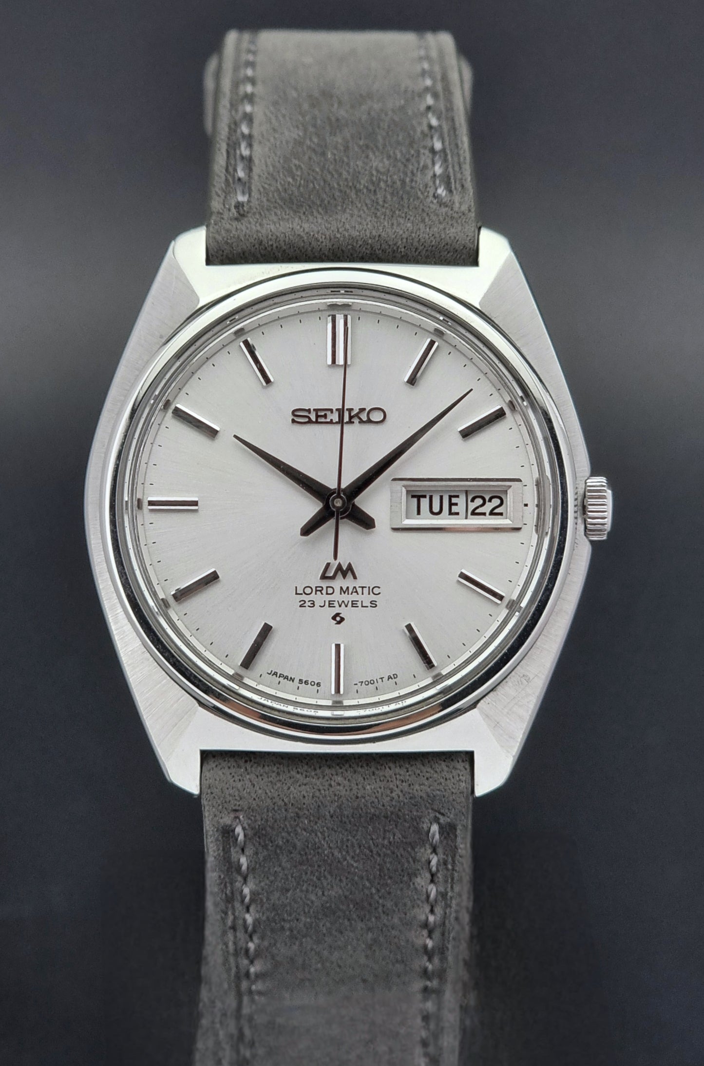 Vintage Seiko Wristwatch LordMatic 5606-7000with gray strap on a dark background