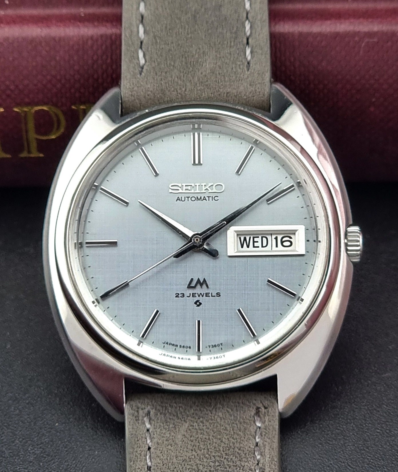 Seiko watch with gray leather strap on a dark background