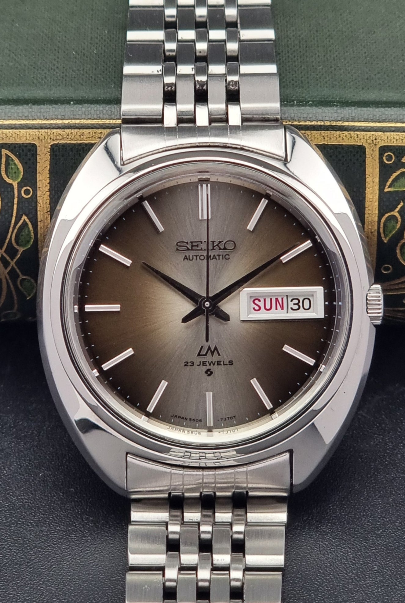Silver Vintage Seiko Lord Matic watch with brown dial on a dark background