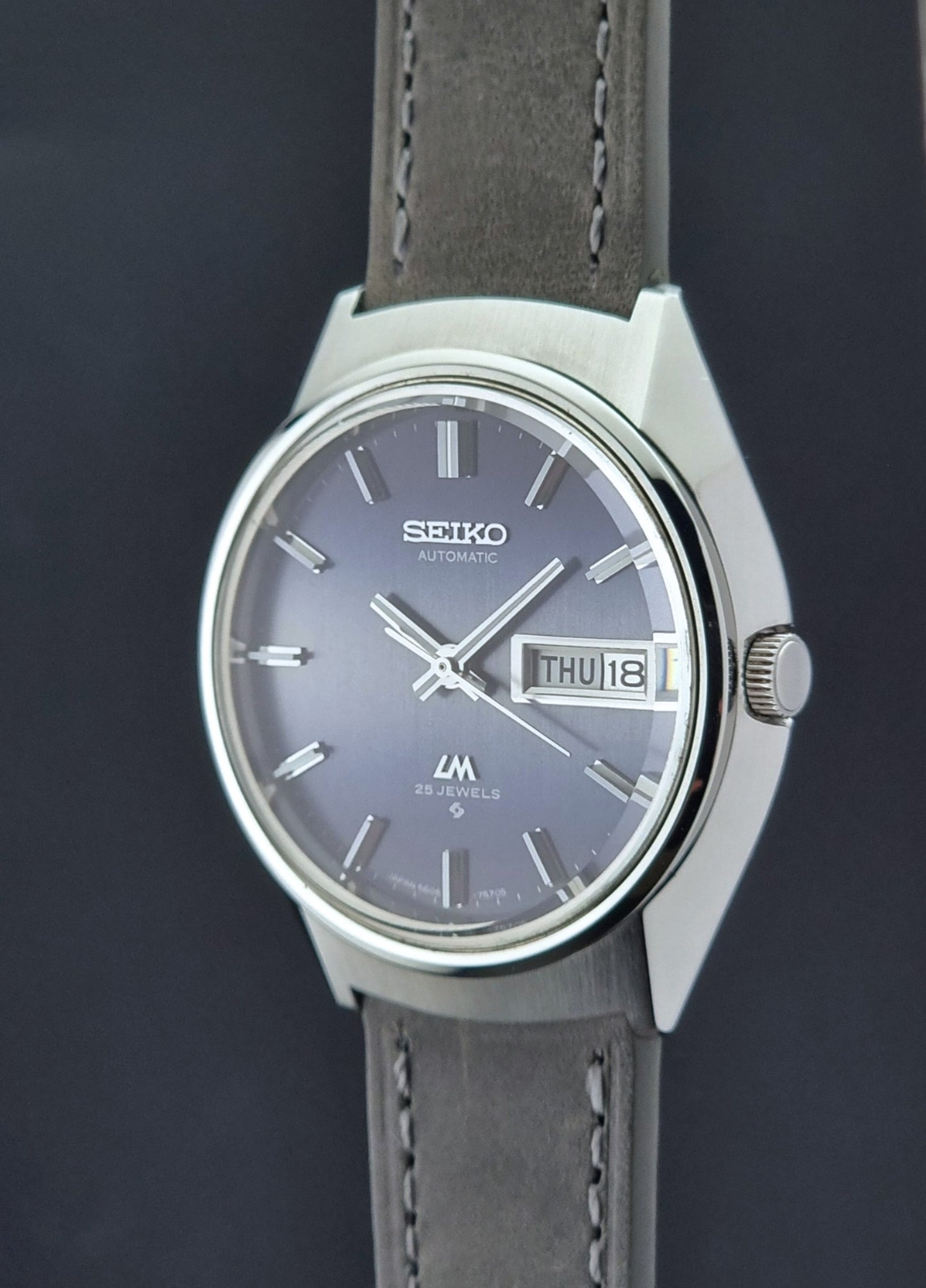 Vintage Seiko 5606-7240 watch with blue dial on a dark background
