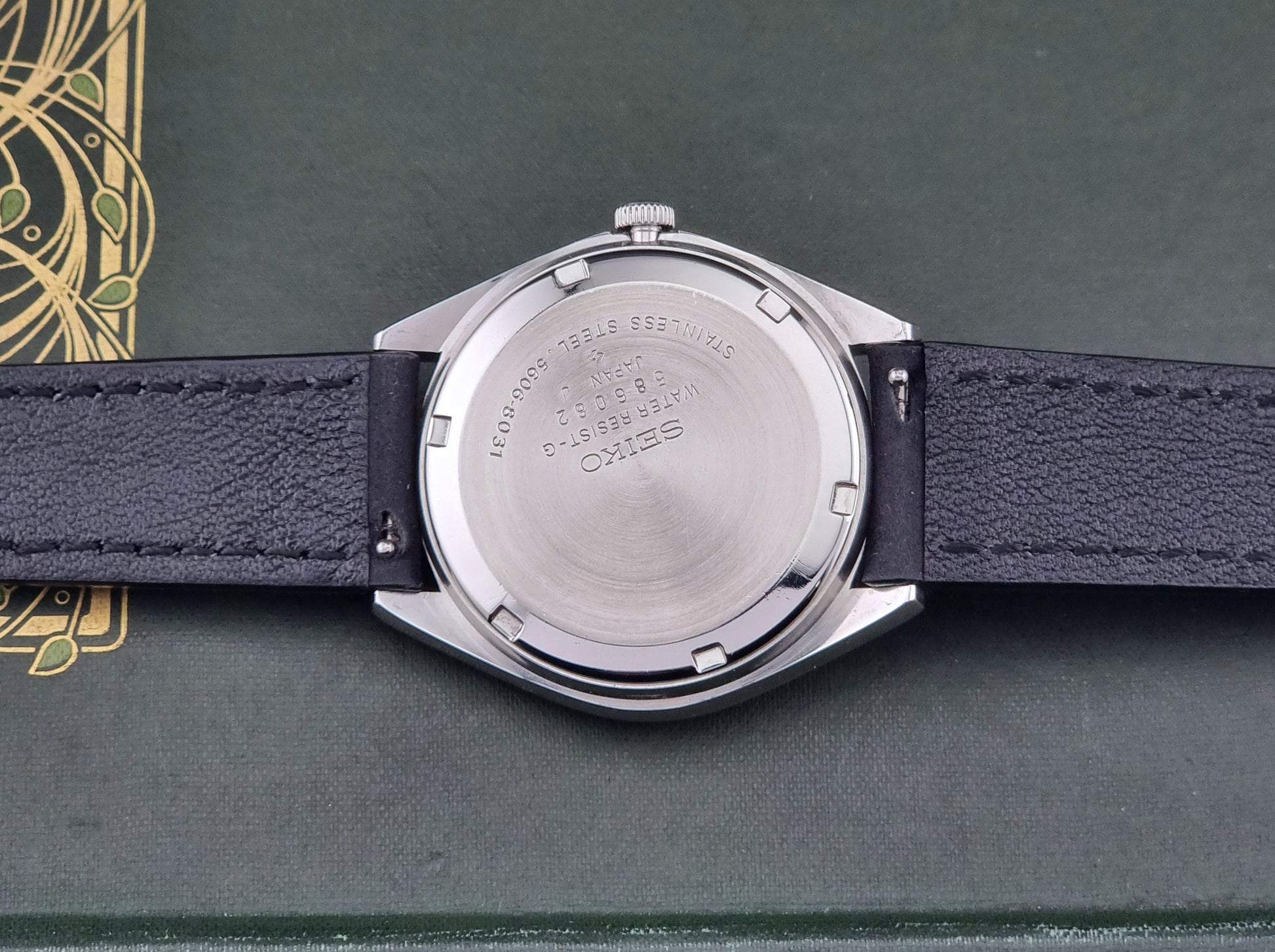 Vintage Seiko Lordmatic 5606-8031 watch with a brown dial and a dark strap case back view