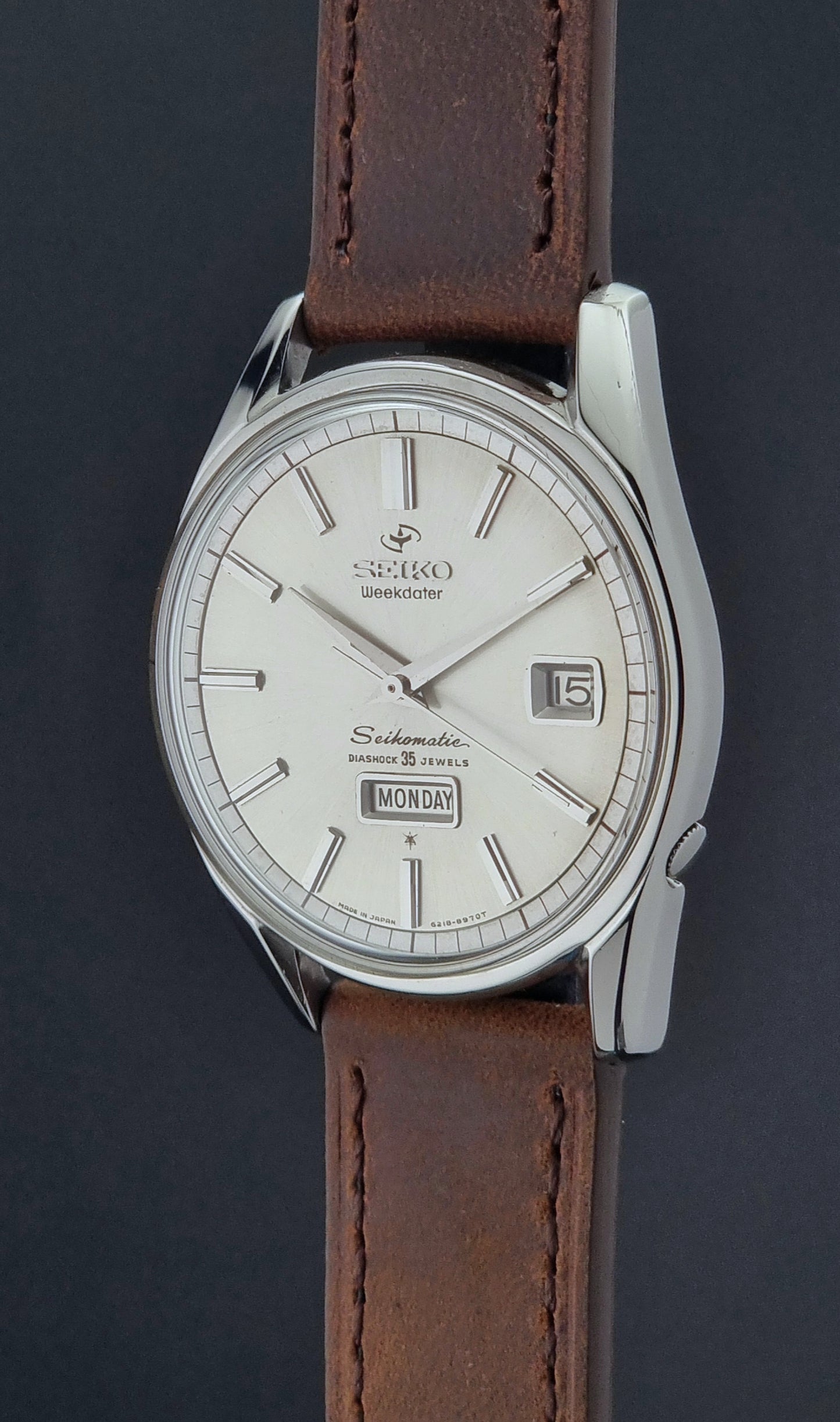Vintage Seiko watch with brown leather strap on a dark background