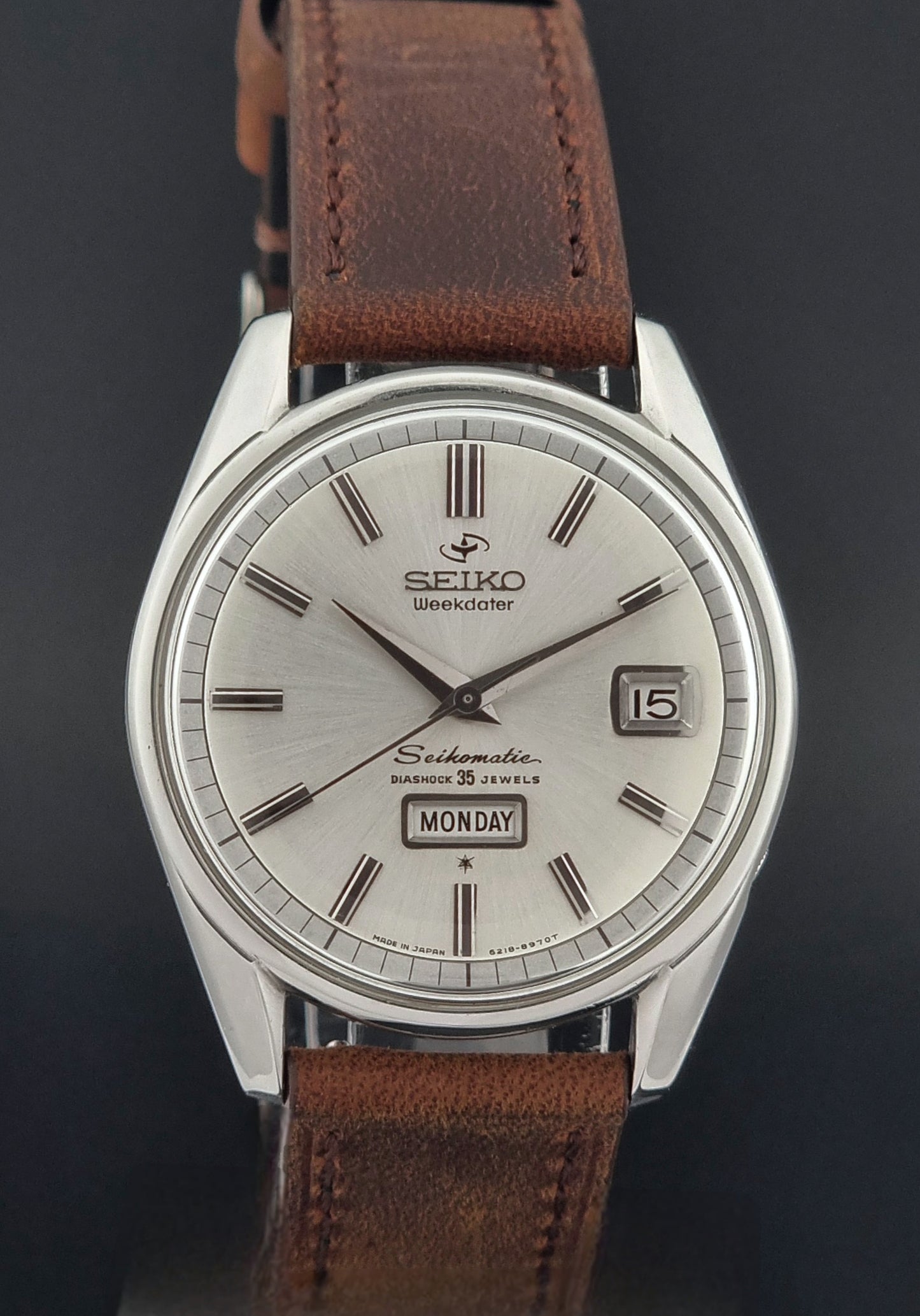 Seiko watch with brown leather strap on a dark background