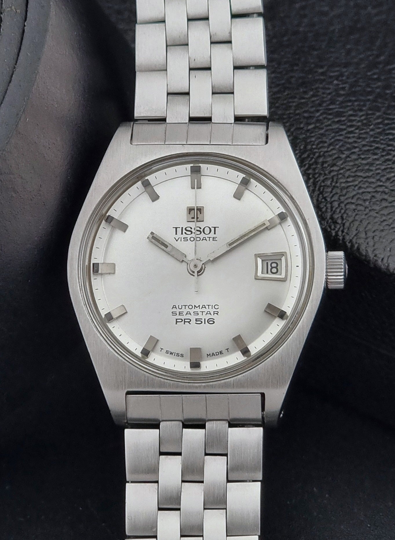 Tissot Seastar Visodate watch with a white face on a dark background