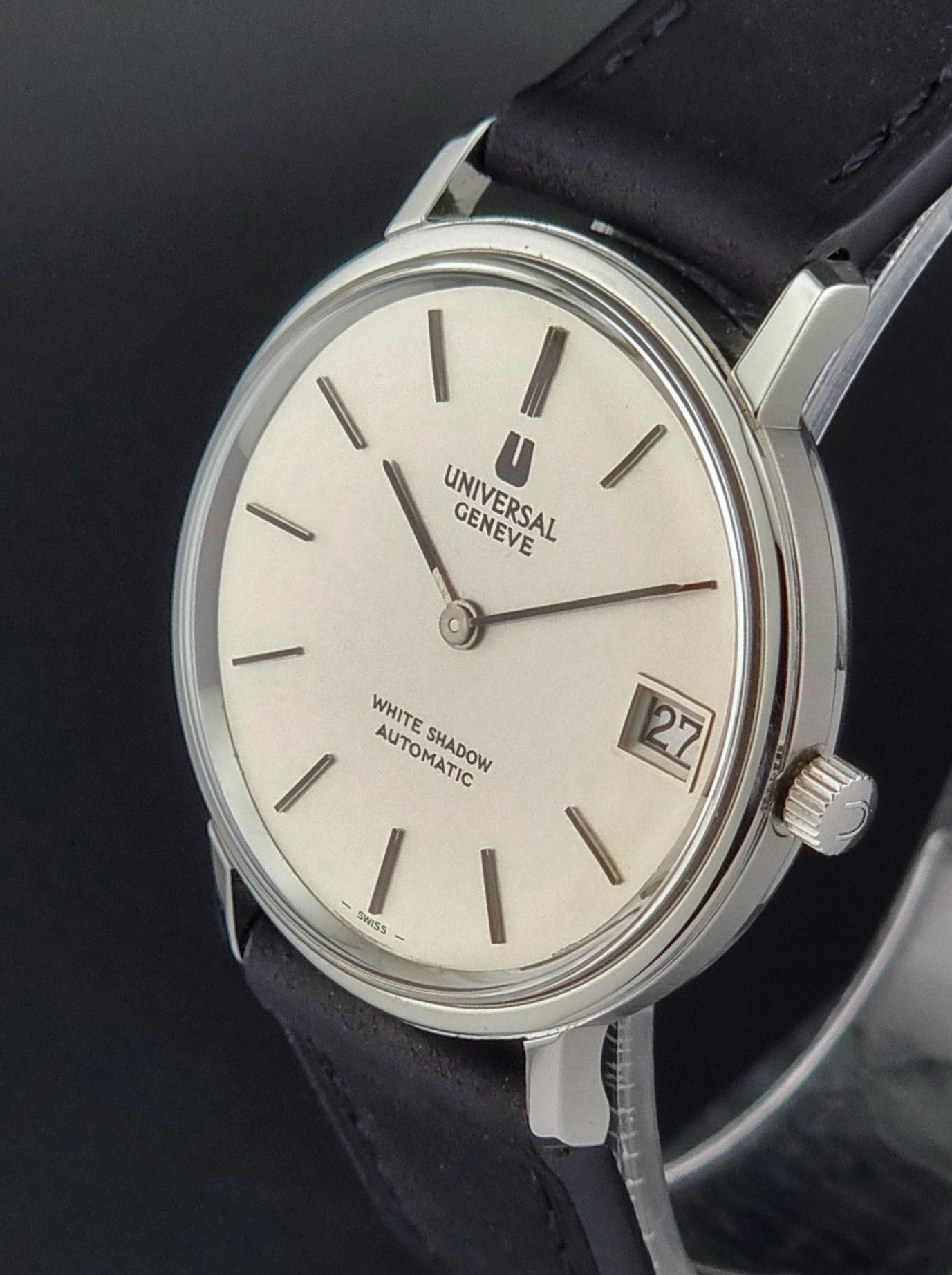 Universal Geneve watch with black strap on a dark background