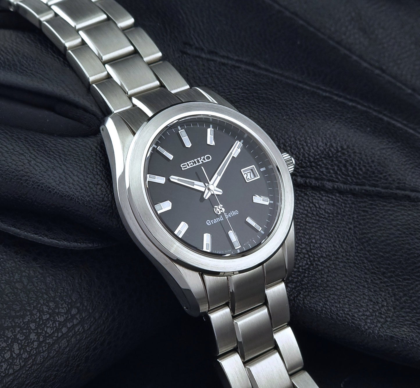 Grand Seiko quartz watch 8J56-8020 with a dark face on a dark background side view