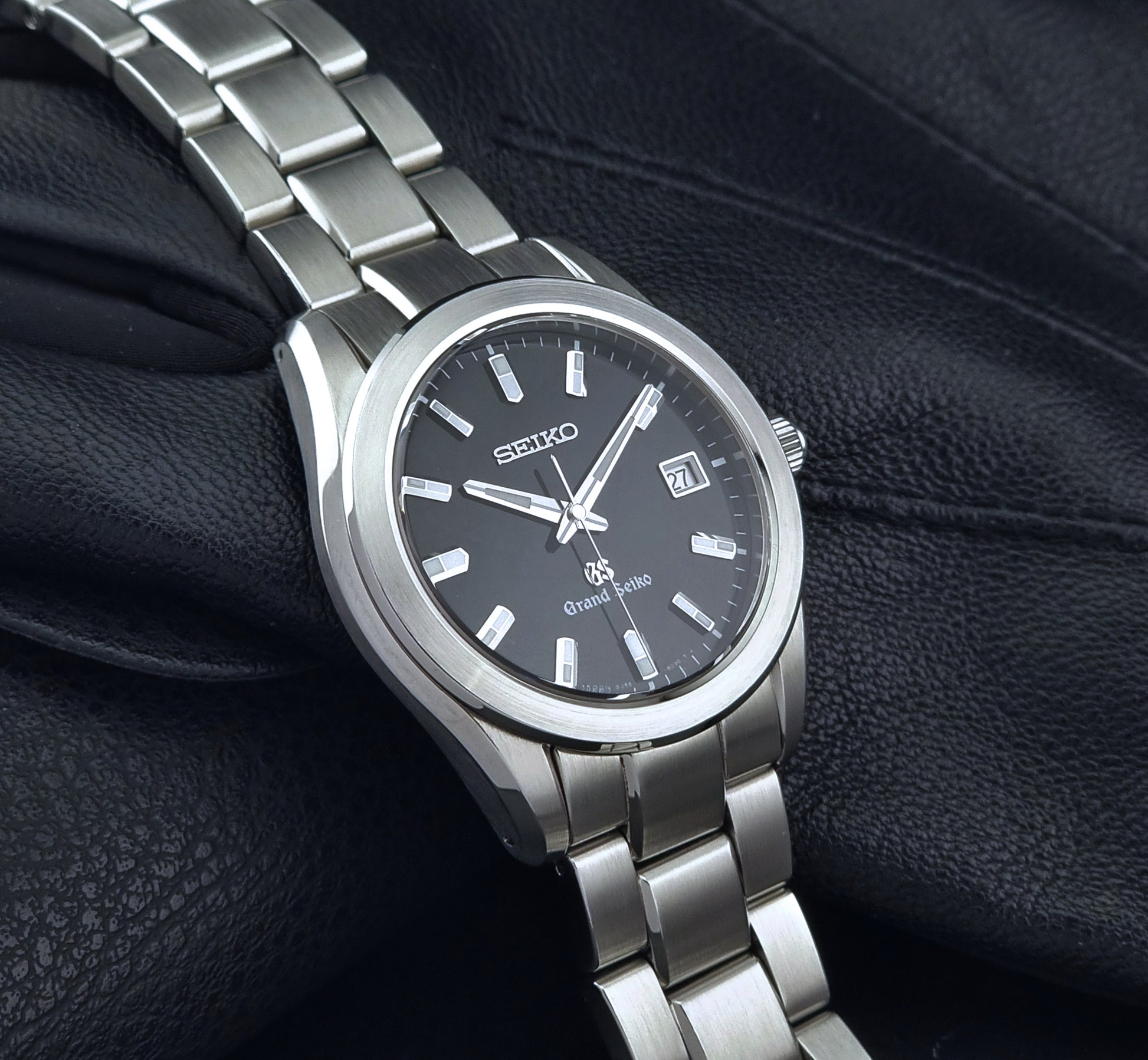 Grand Seiko quartz watch 8J56-8020 with a dark face on a dark background side view