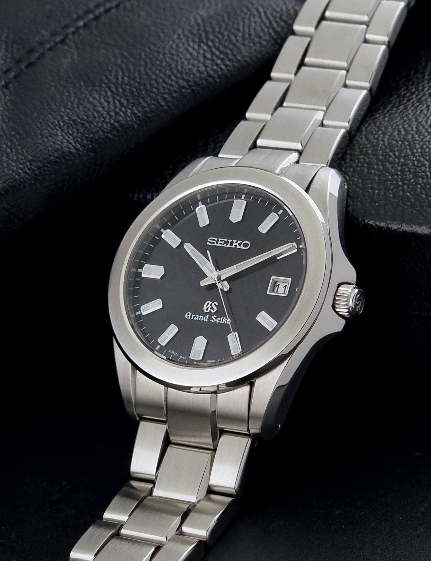 Grand Seiko SBGF021 quartz watch 8J56-8020 on its side resting in a dark background
