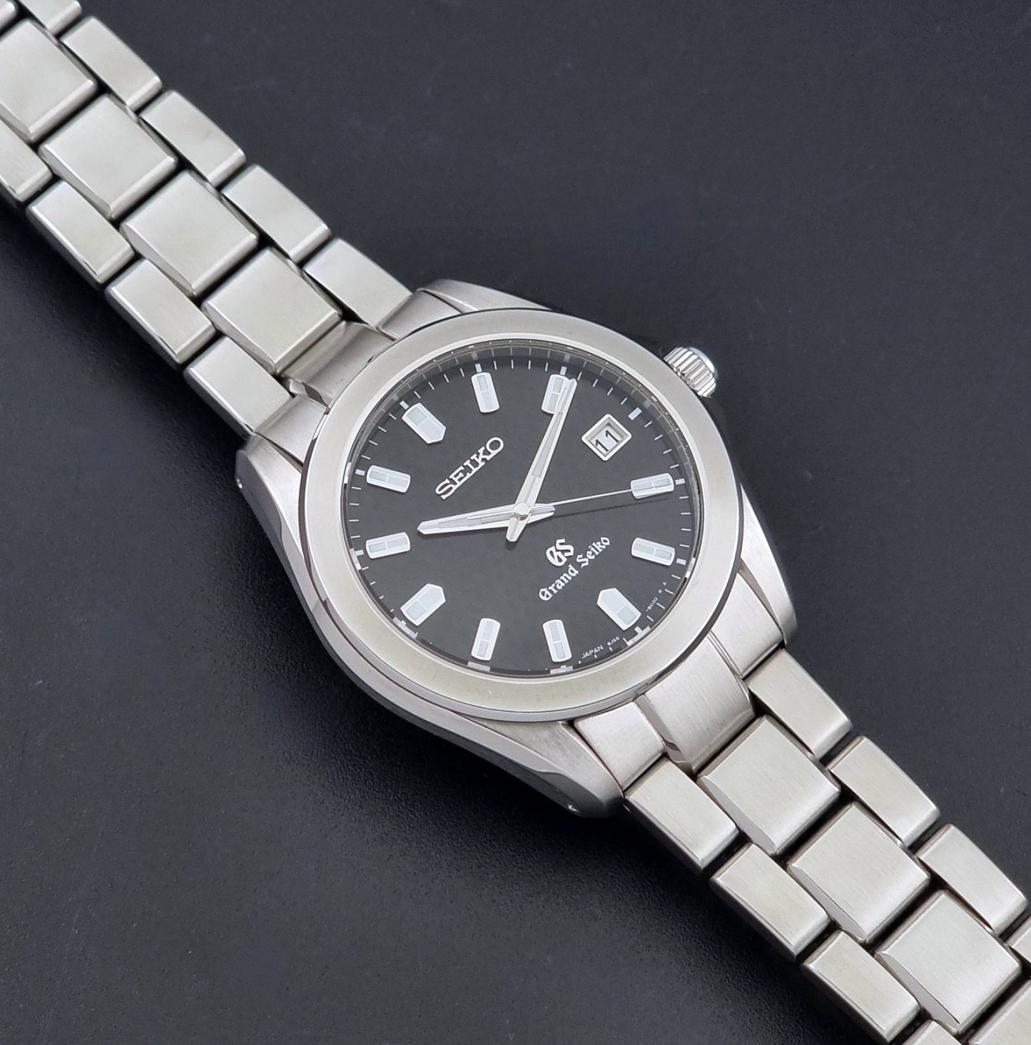 Grand Seiko SBGF021 quartz watch 8J56-8020 angled view on a dark backgound