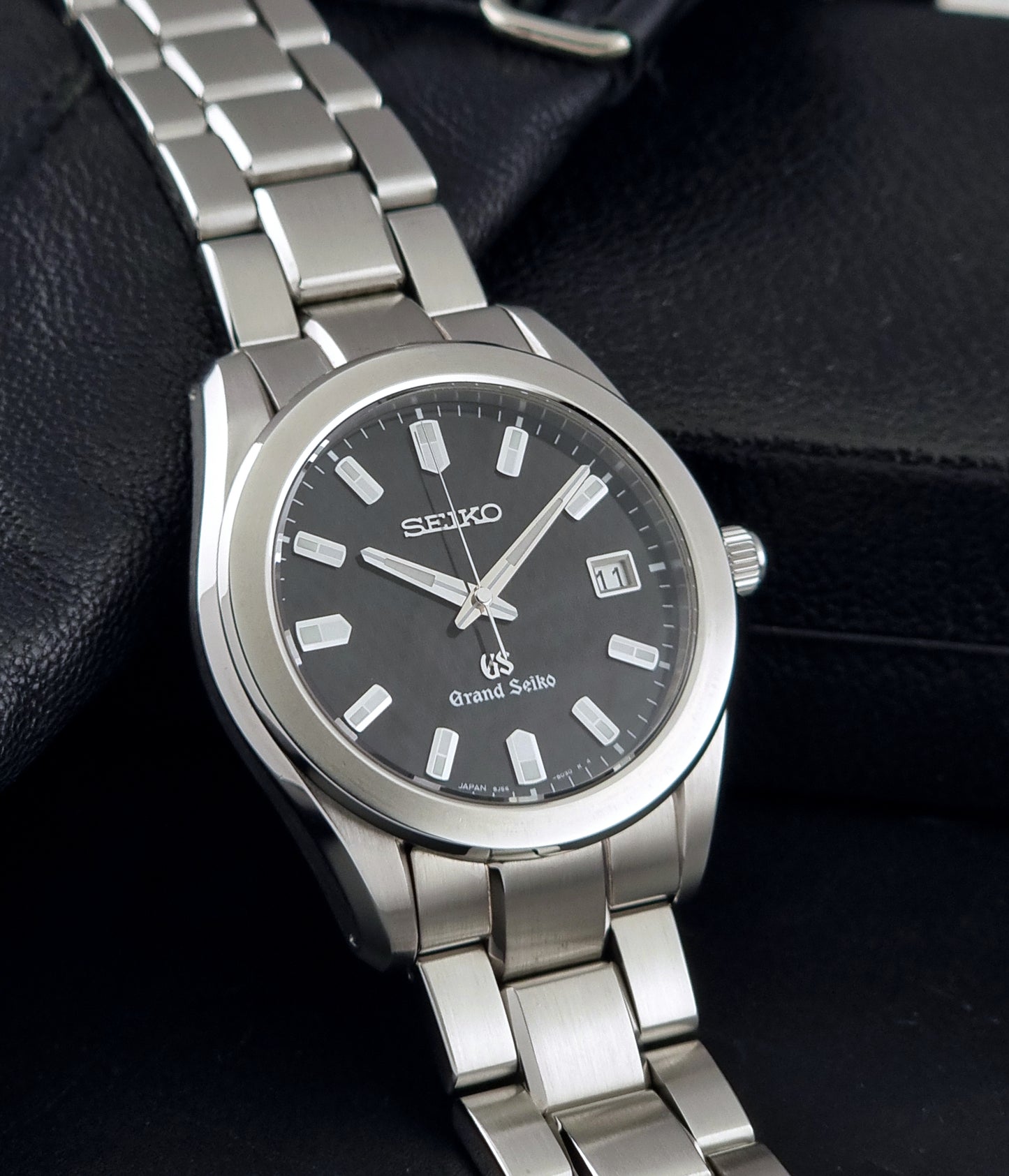 Grand Seiko SBGF021 quartz watch 8J56-8020 resting on a dark background