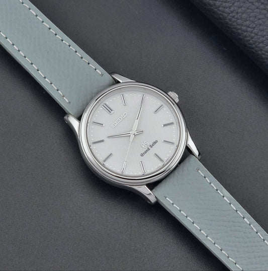 Grand Seiko SBGF029 quartz watch 8J55-0AA0  with light grey strap and silver case on a dark grey background dial