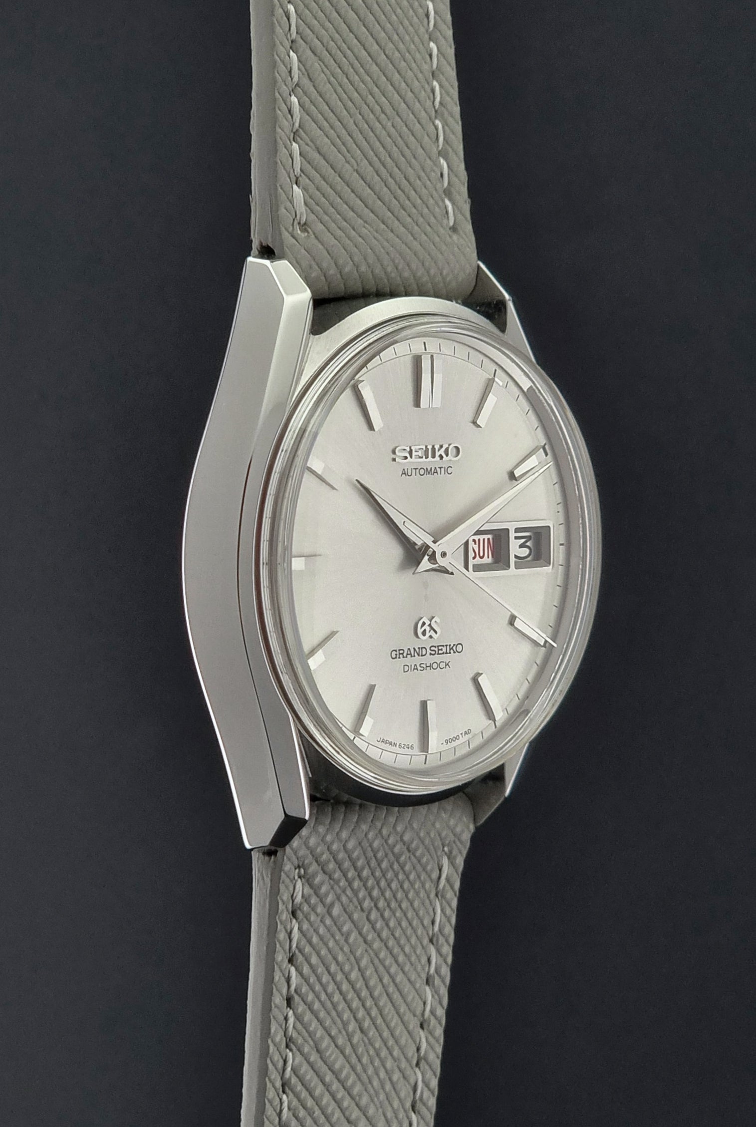 Vintage Grand Seiko watch with gray strap on a dark background