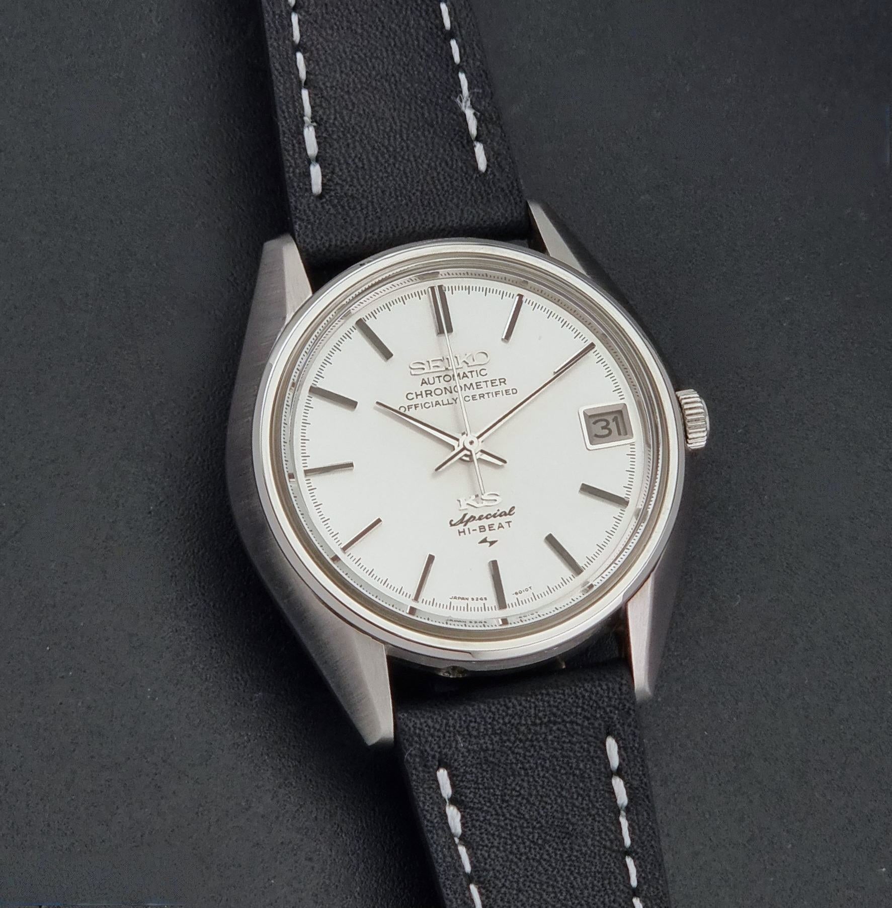 A Vintage King Seiko Special 5245-6010 Watch, white dial, and black leather strap with white stitching, photographed close up