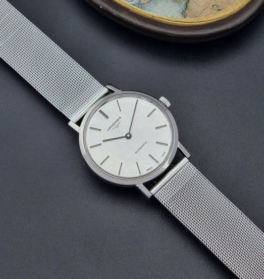 Vintage Longines Wristwatch 3029 with mesh strap on a dark surface dial