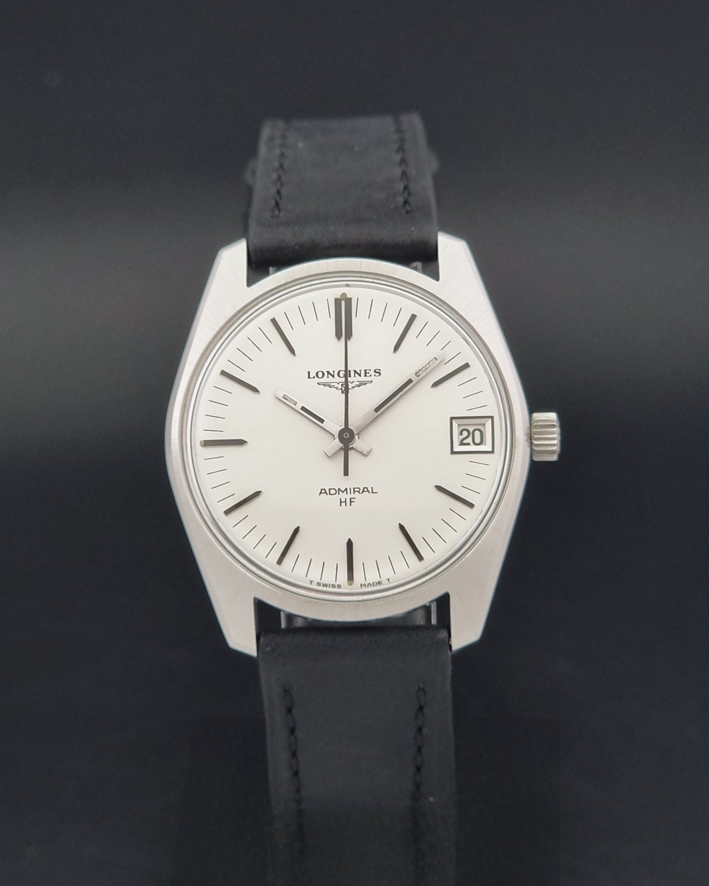 A Vintage Longines Admiral HF 2302 Wristwatch and black leather strap, photographed against a dark background.