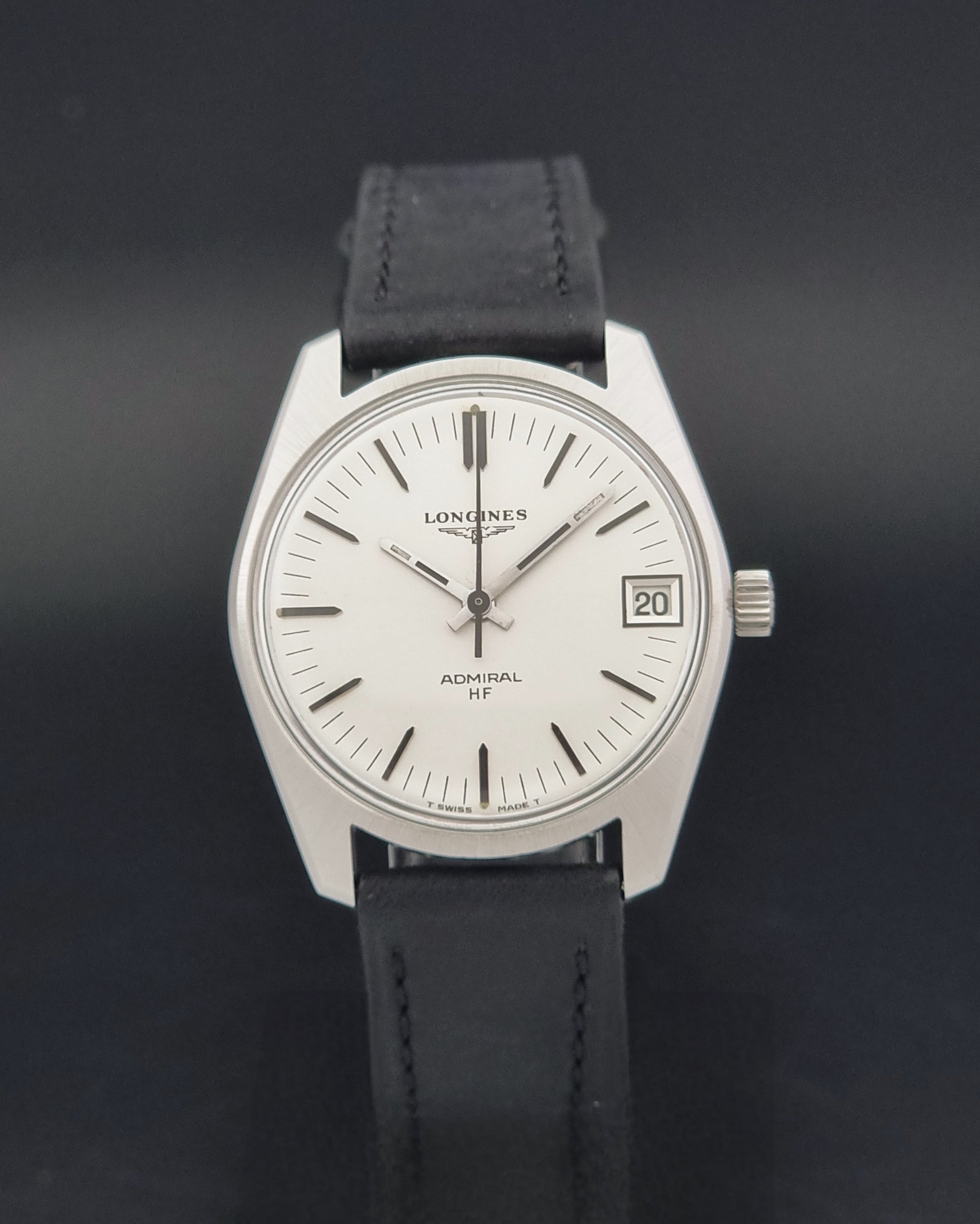 A Vintage Longines Admiral HF 2302 Wristwatch and black leather strap, photographed against a dark background.