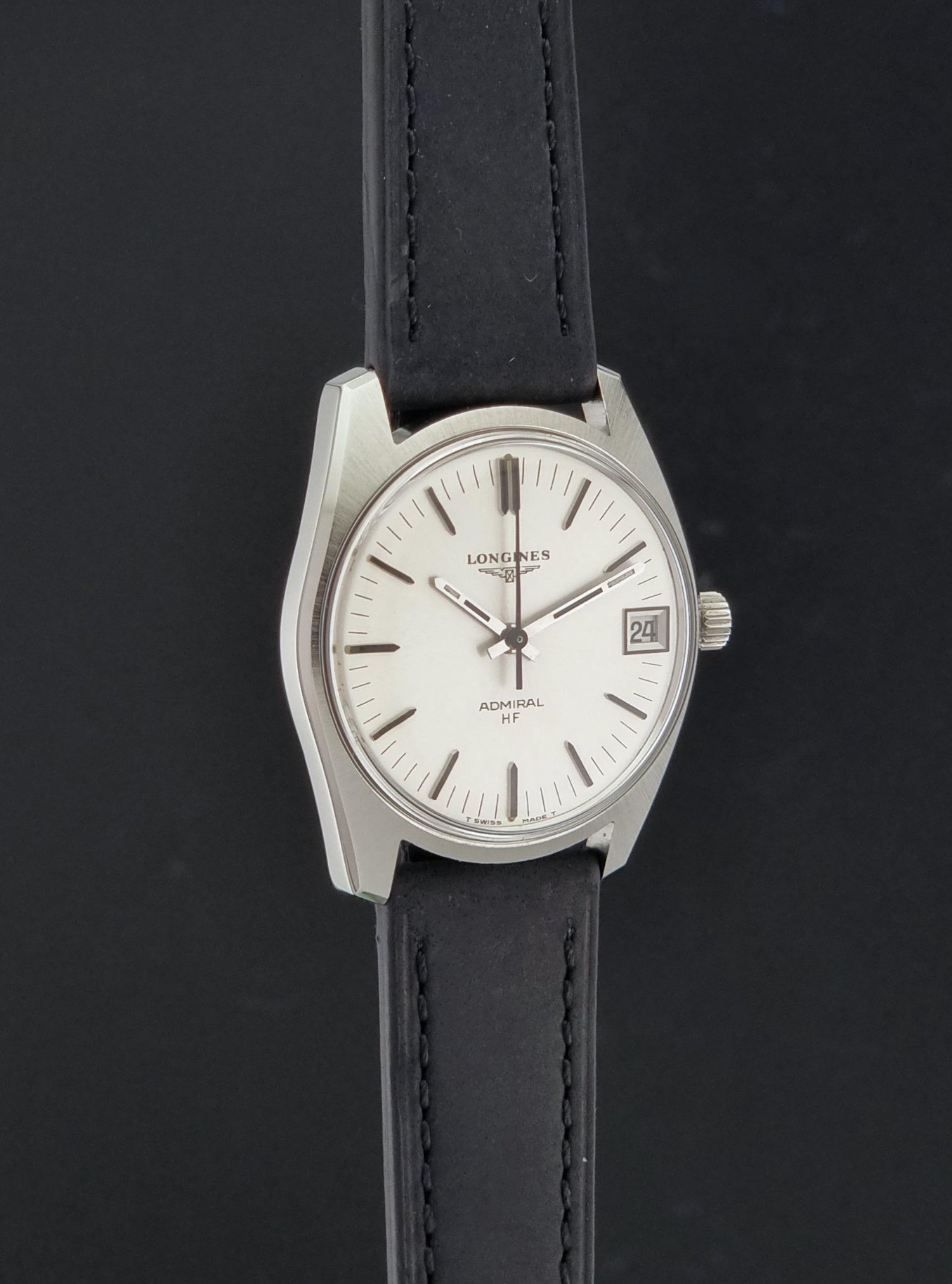 A Vintage Longines Admiral HF 2302 Wristwatch and black leather strap, photographed against a dark background.