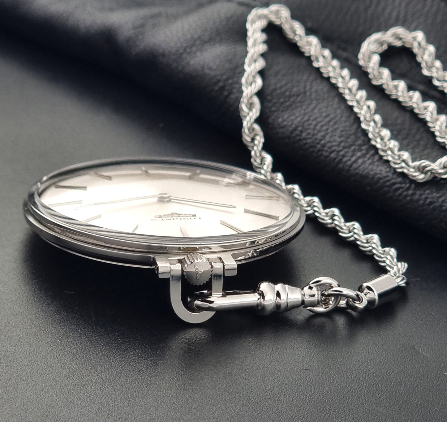 a Vintage Longines 7713 pocket watch crown view on a dark background