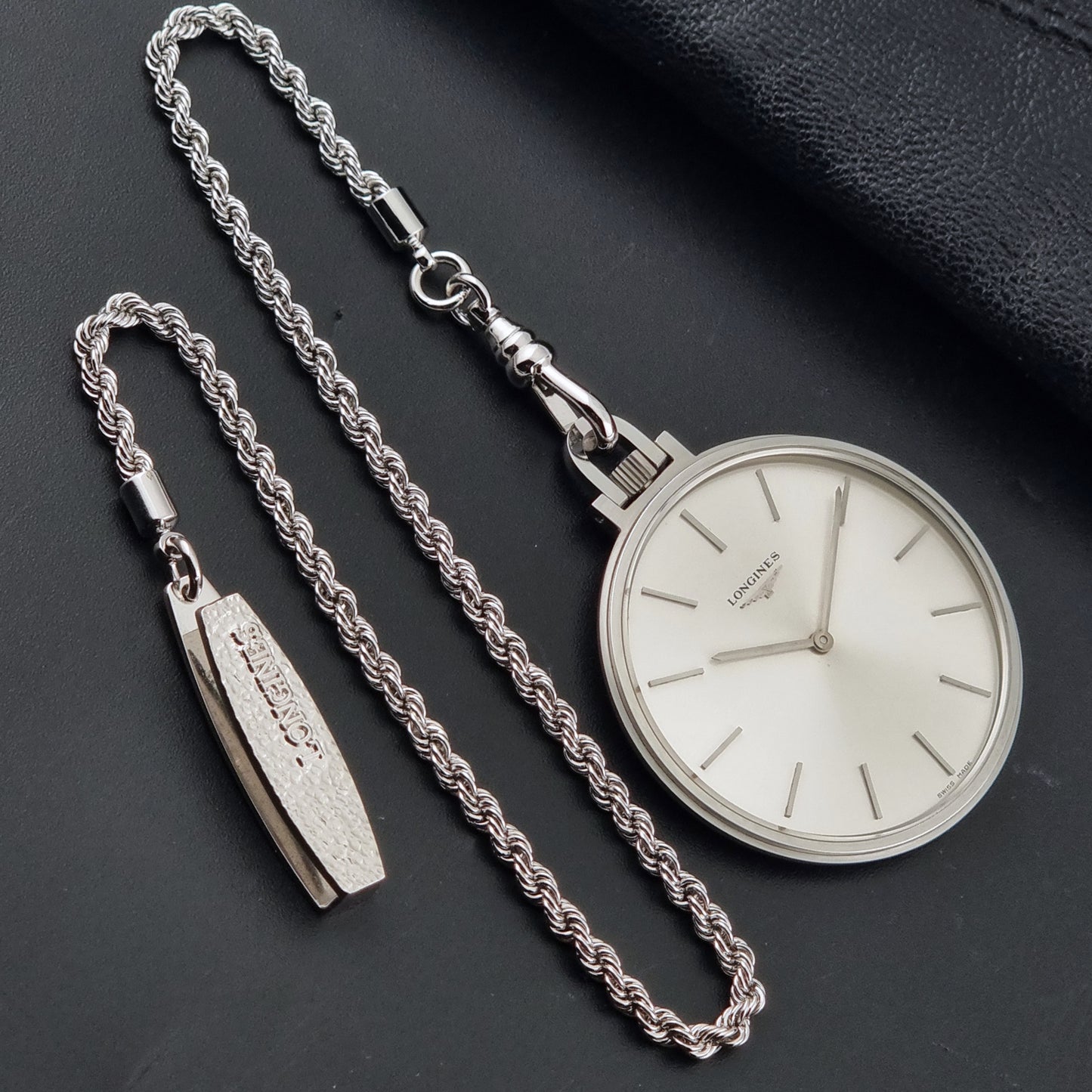 A Vintage Longines pocket watch on a dark background