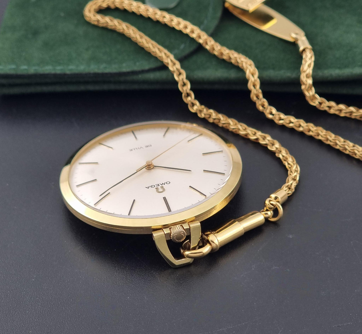 Vintage Omega De Ville Pocket Watch 1714 side profile showing the crown on a dark background