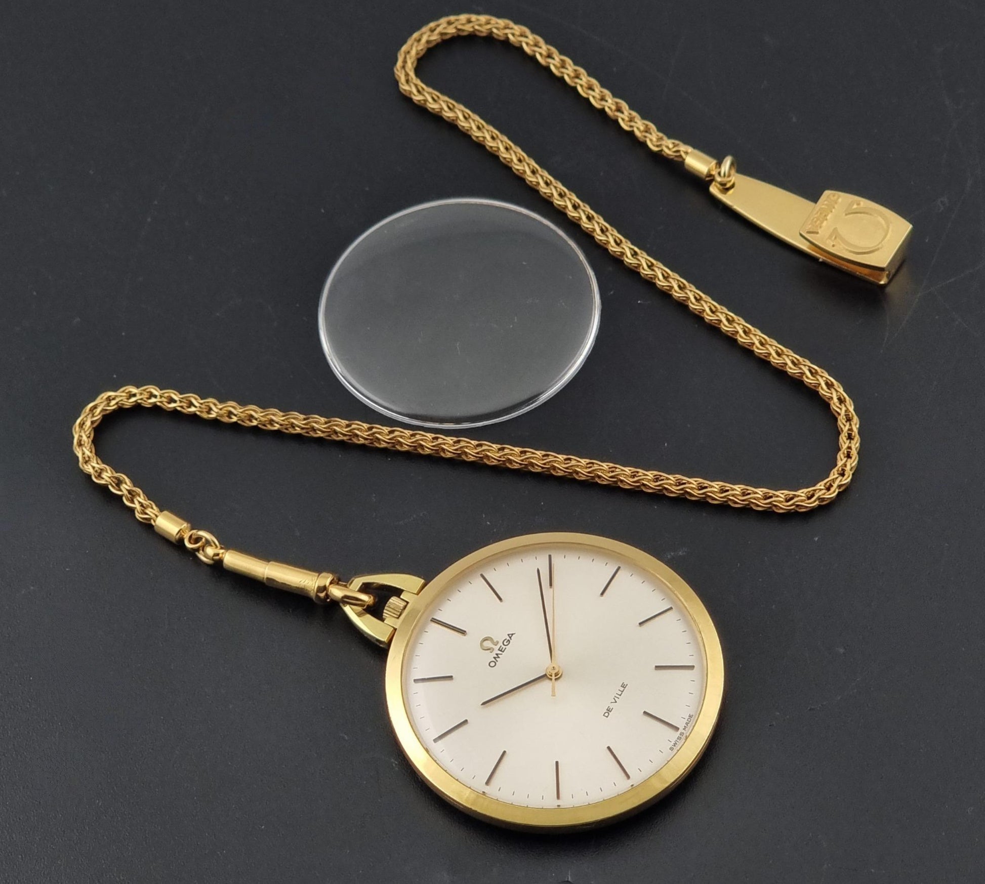 Vintage Omega De Ville Pocket Watch 1714  on a dark background with its original crystal