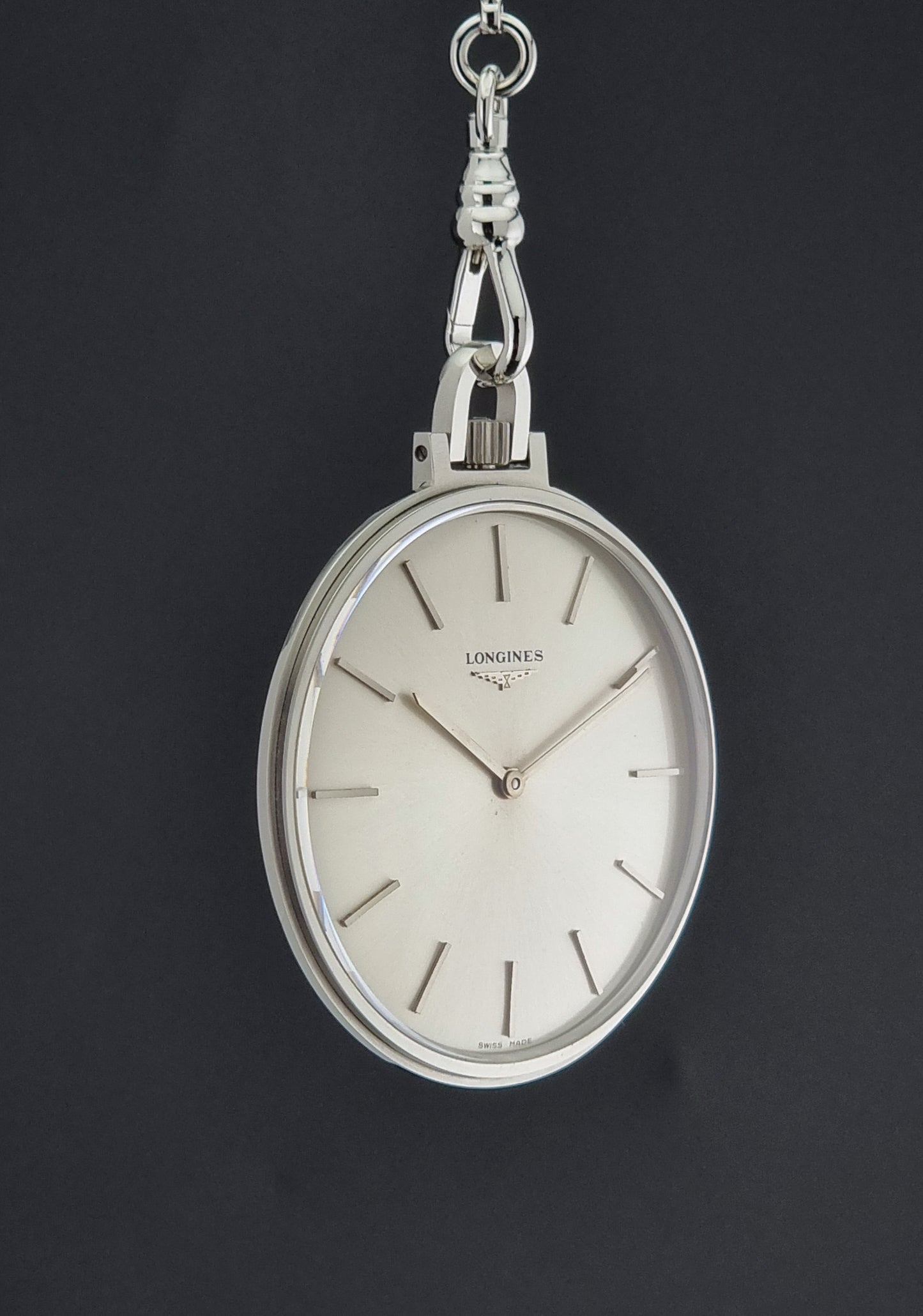 A Vintage Longines pocket watch on a dark back ground