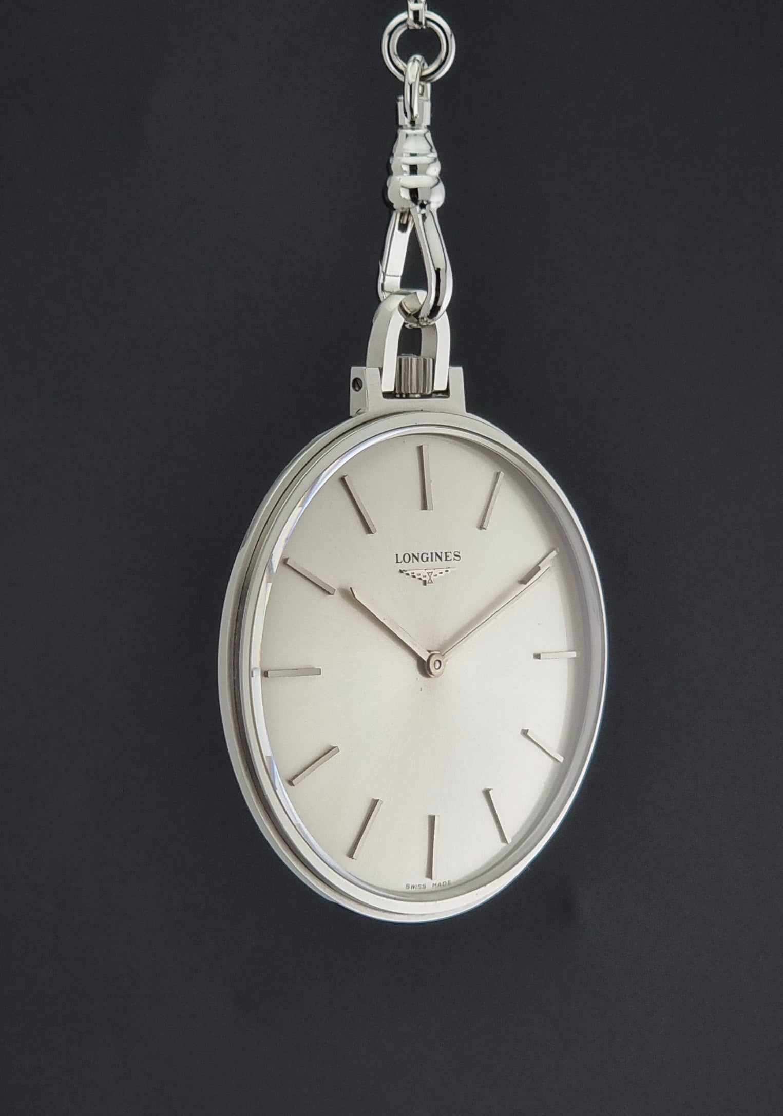 A Vintage Longines pocket watch on a dark back ground