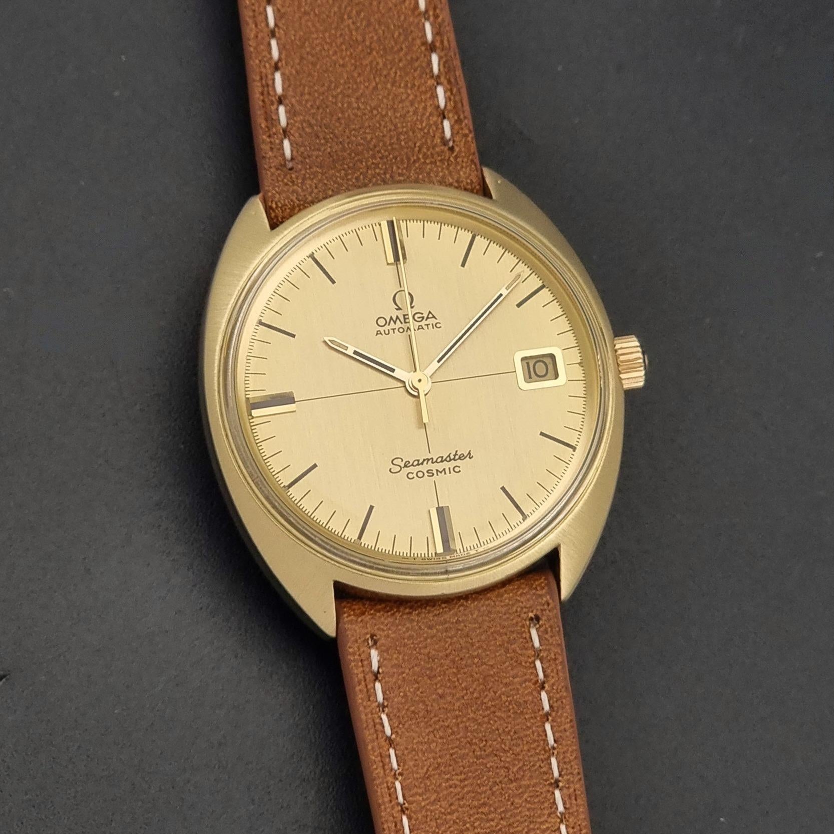 A Vintage Omega 166.026 Seamaster Cosmic Automatic Gold Capped watch on a dark background front view