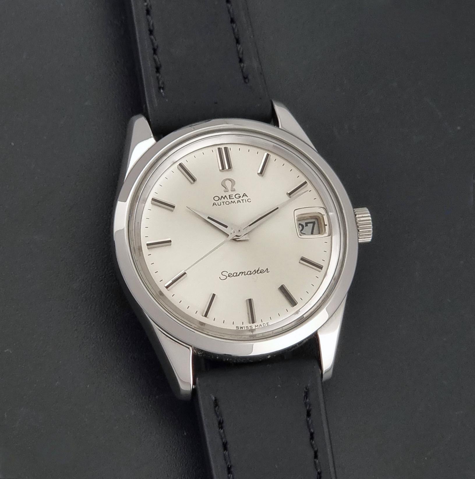 A Vintage Omega Seamaster 166.010 Wristwatch close up of the dial on a dark background