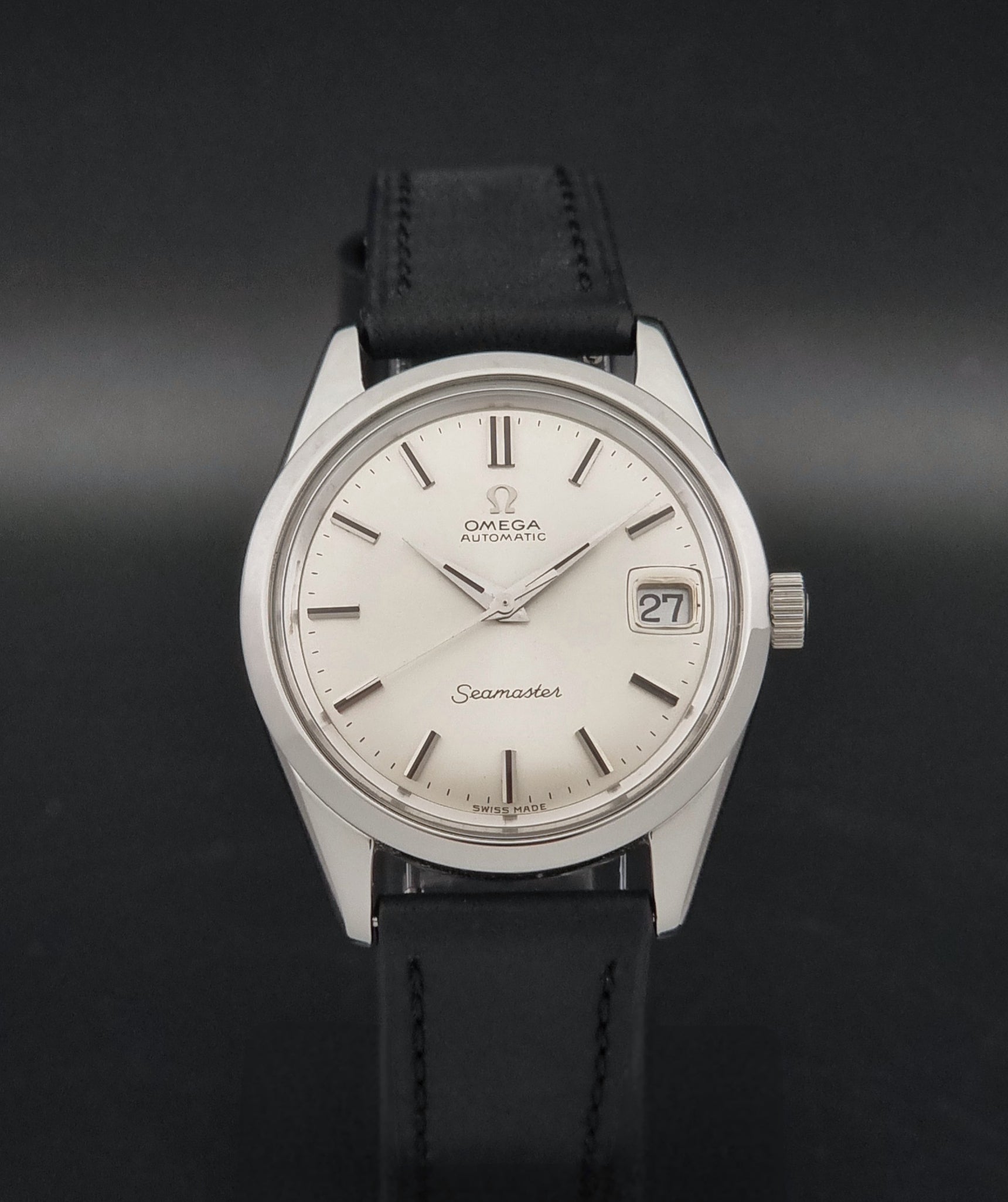 A Vintage Omega Seamaster 166.010 Wristwatch on a dark background 