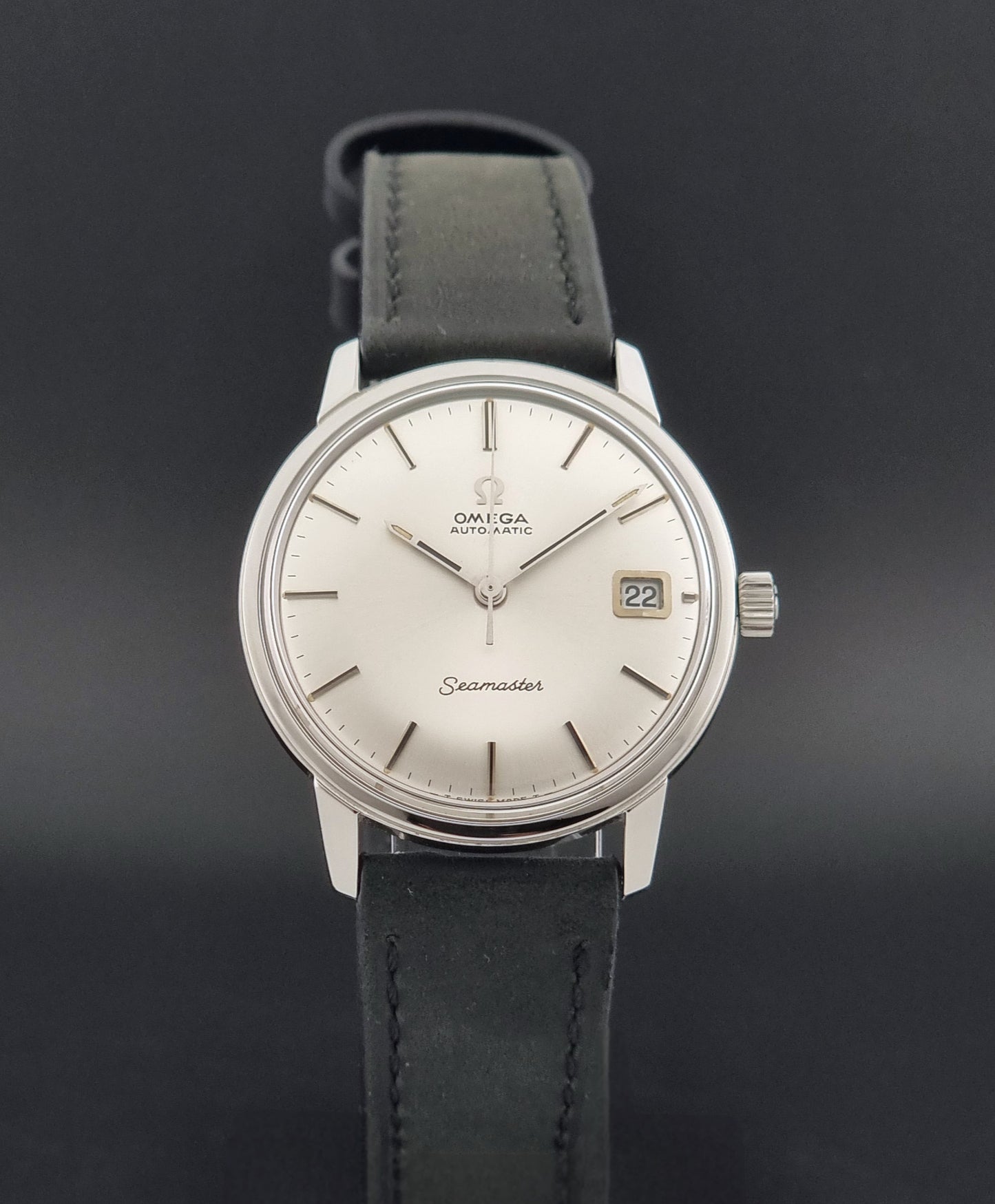 A Vintage Omega Seamaster watch 166.037 wristwatch a front view against a dark beckground