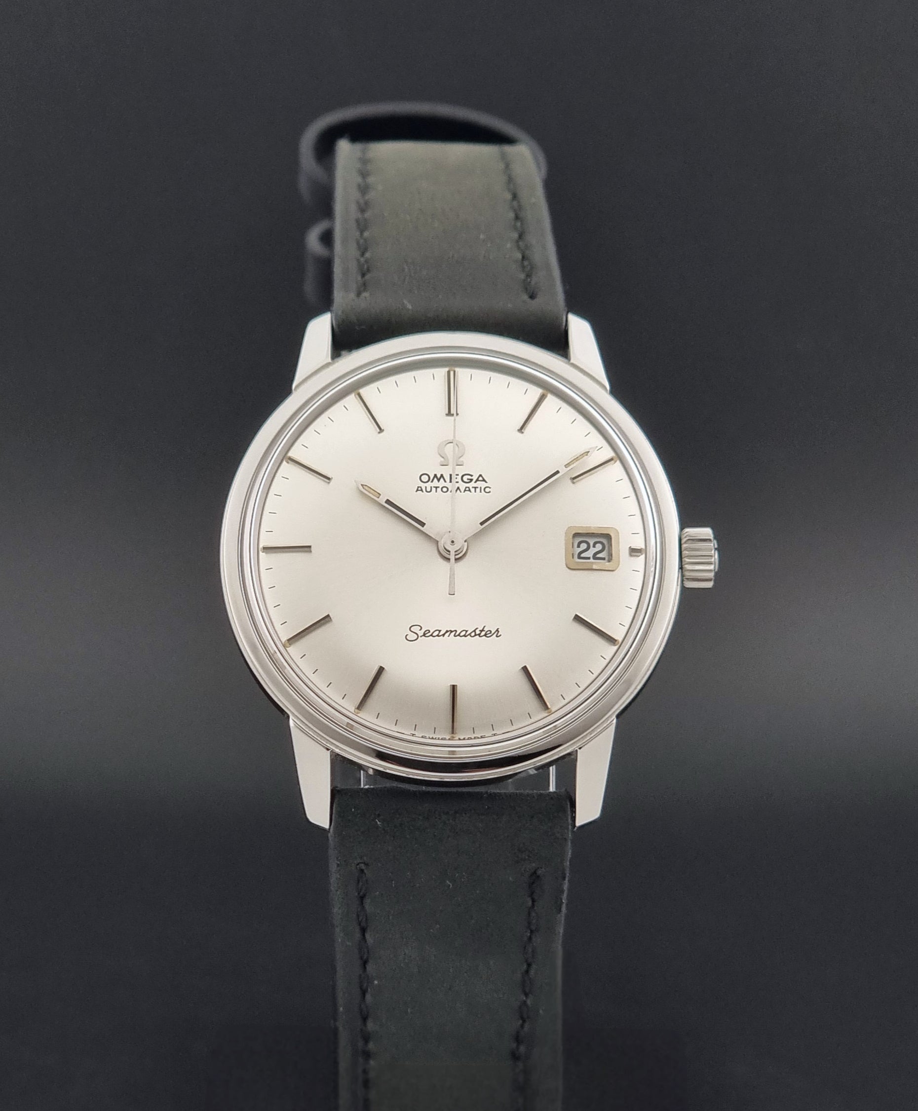 A Vintage Omega Seamaster watch 166.037 wristwatch a front view against a dark beckground
