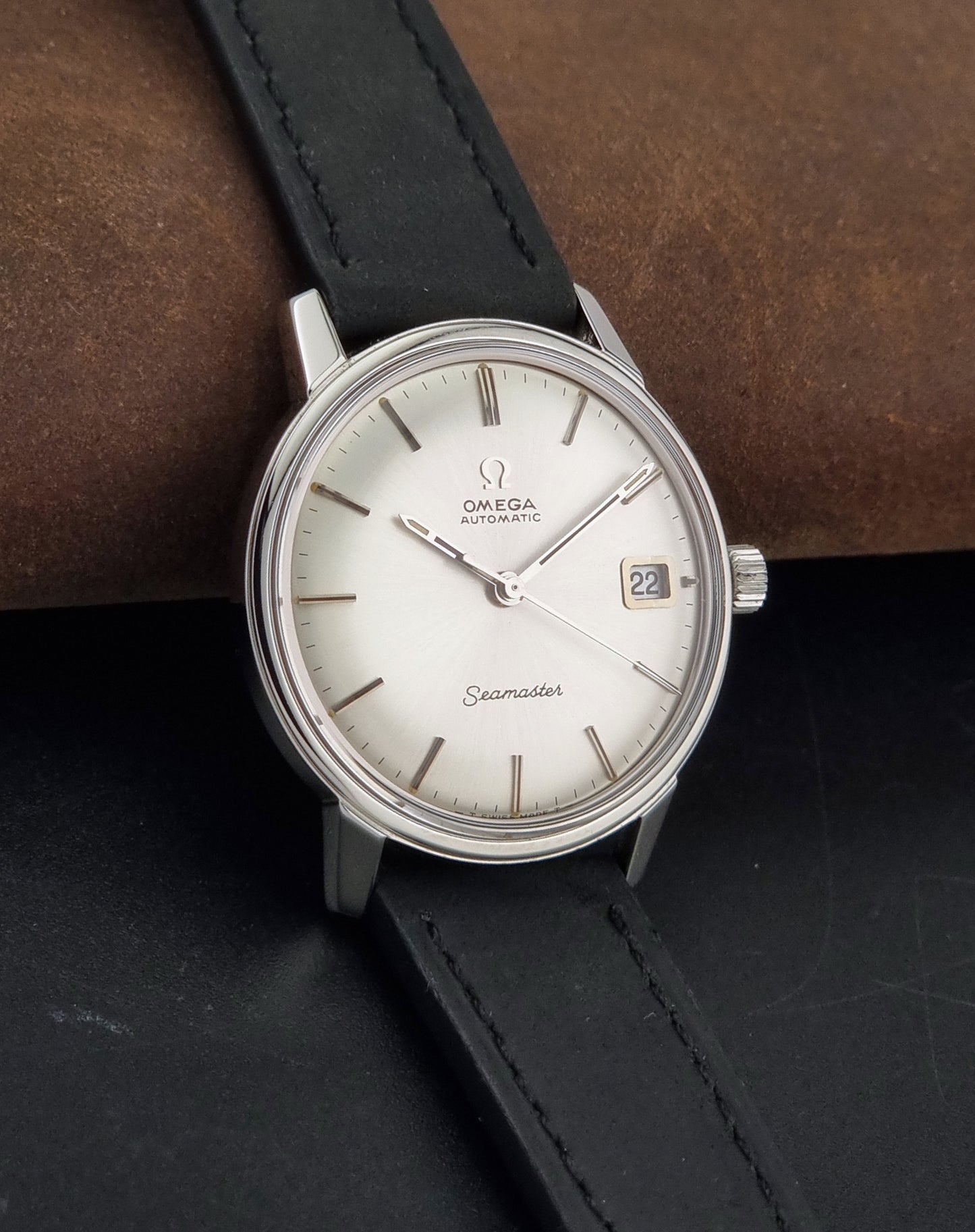 A Vintage Omega Seamaster watch 166.037 wristwatch on a brown leather background