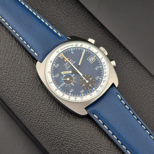 Vintage Omega Seamaster Wristwatch with blue strap and detailed face on a dark textured surface
