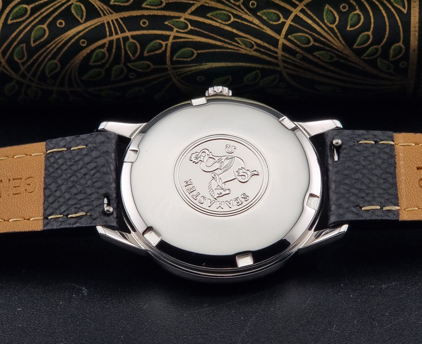 A Vintage Omega Seamaster Wristwatch 166.002 Turler dial on a dark background of the caseback
