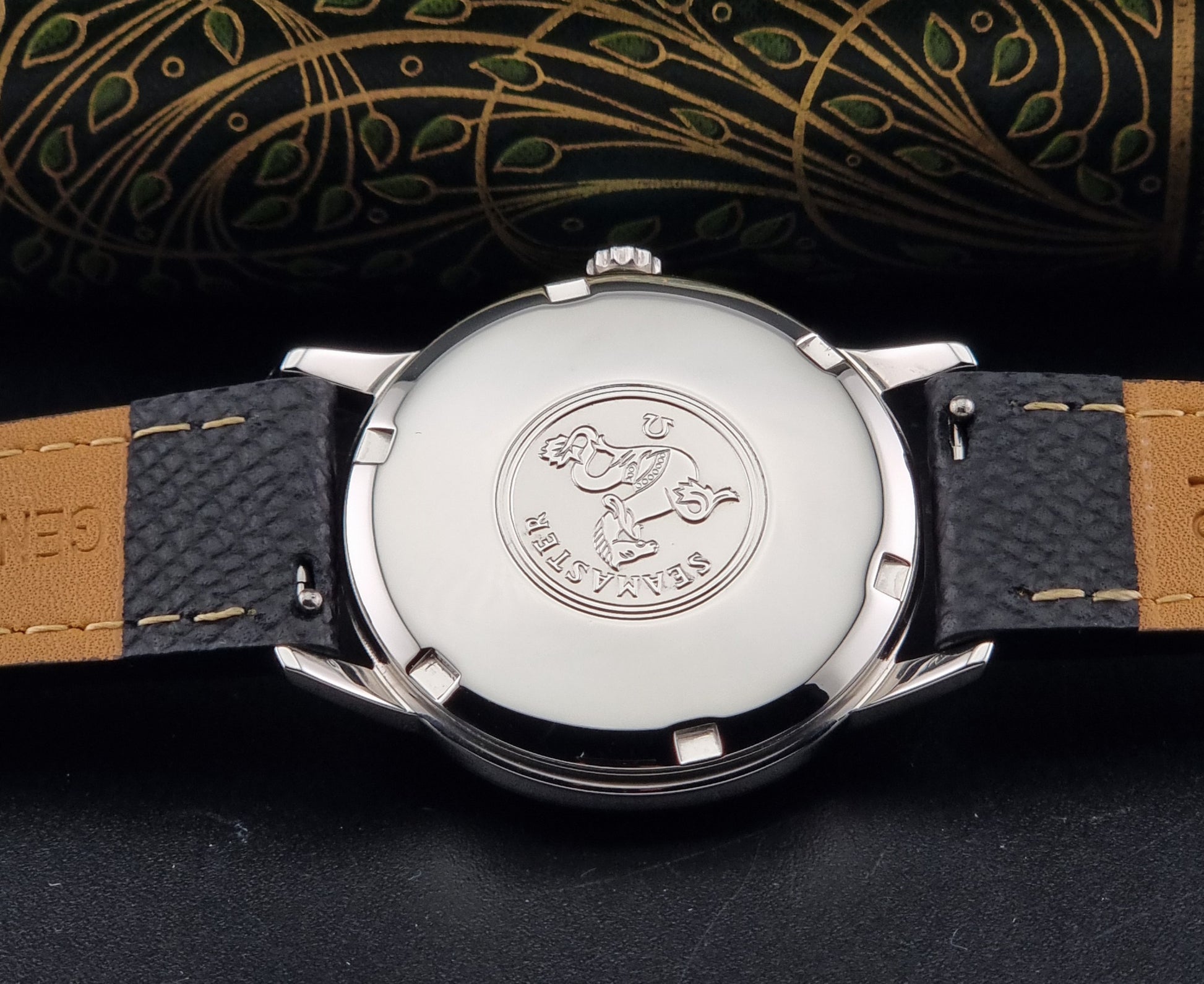 A Vintage Omega Seamaster Wristwatch 166.002 Turler dial on a dark background of the caseback