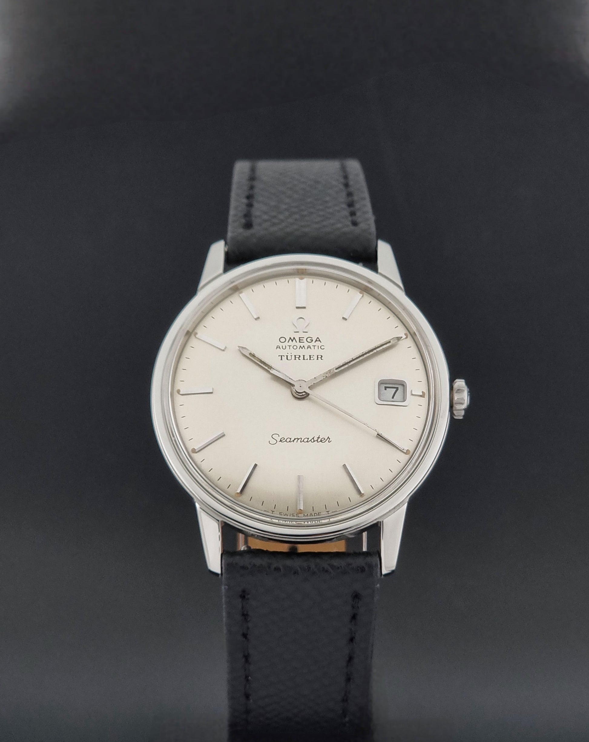 A Vintage Omega Seamaster Wristwatch 166.002 Turler dial on a dark background front close up