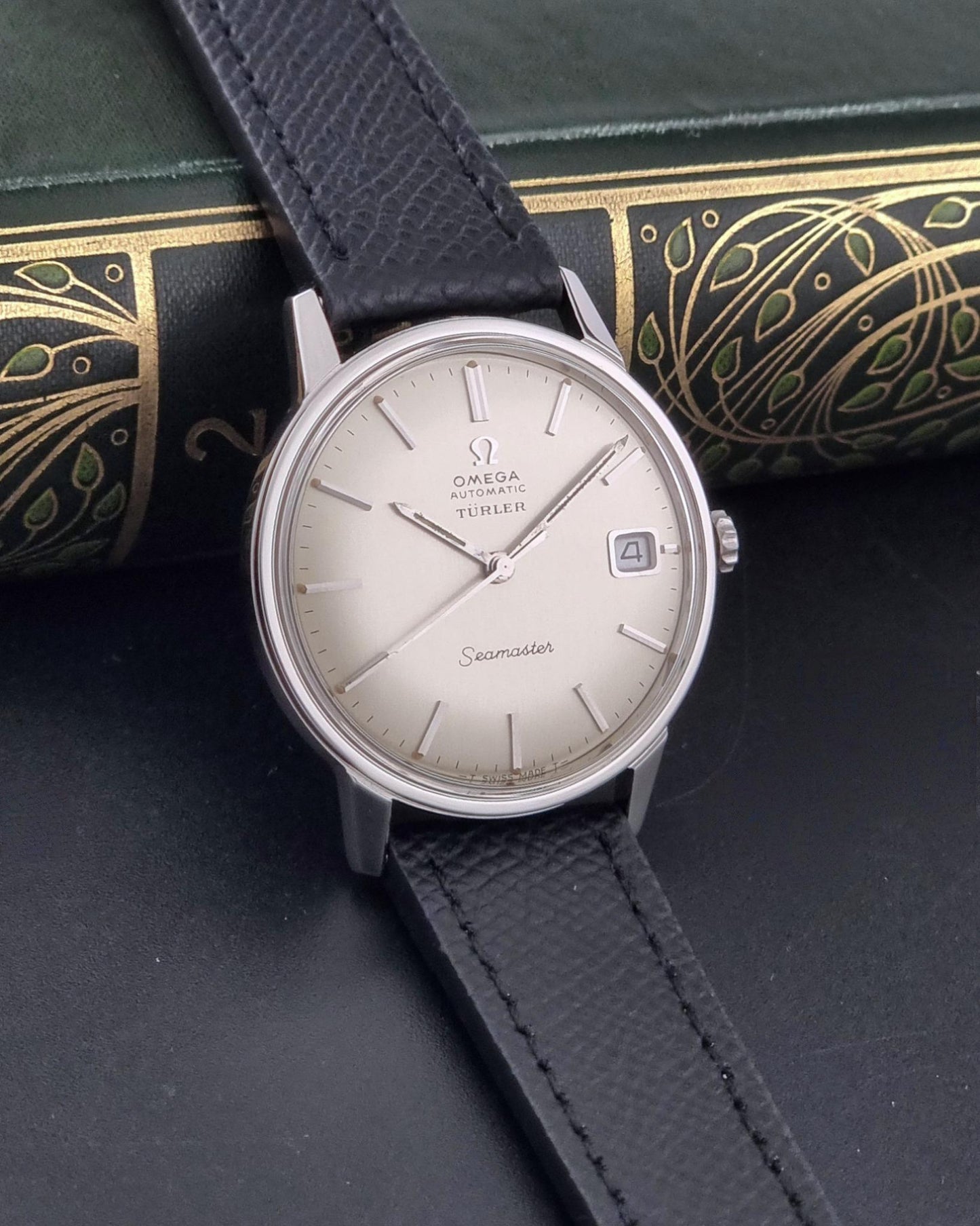 A Vintage Omega Seamaster Wristwatch 166.002 Turler dial on a dark background side view