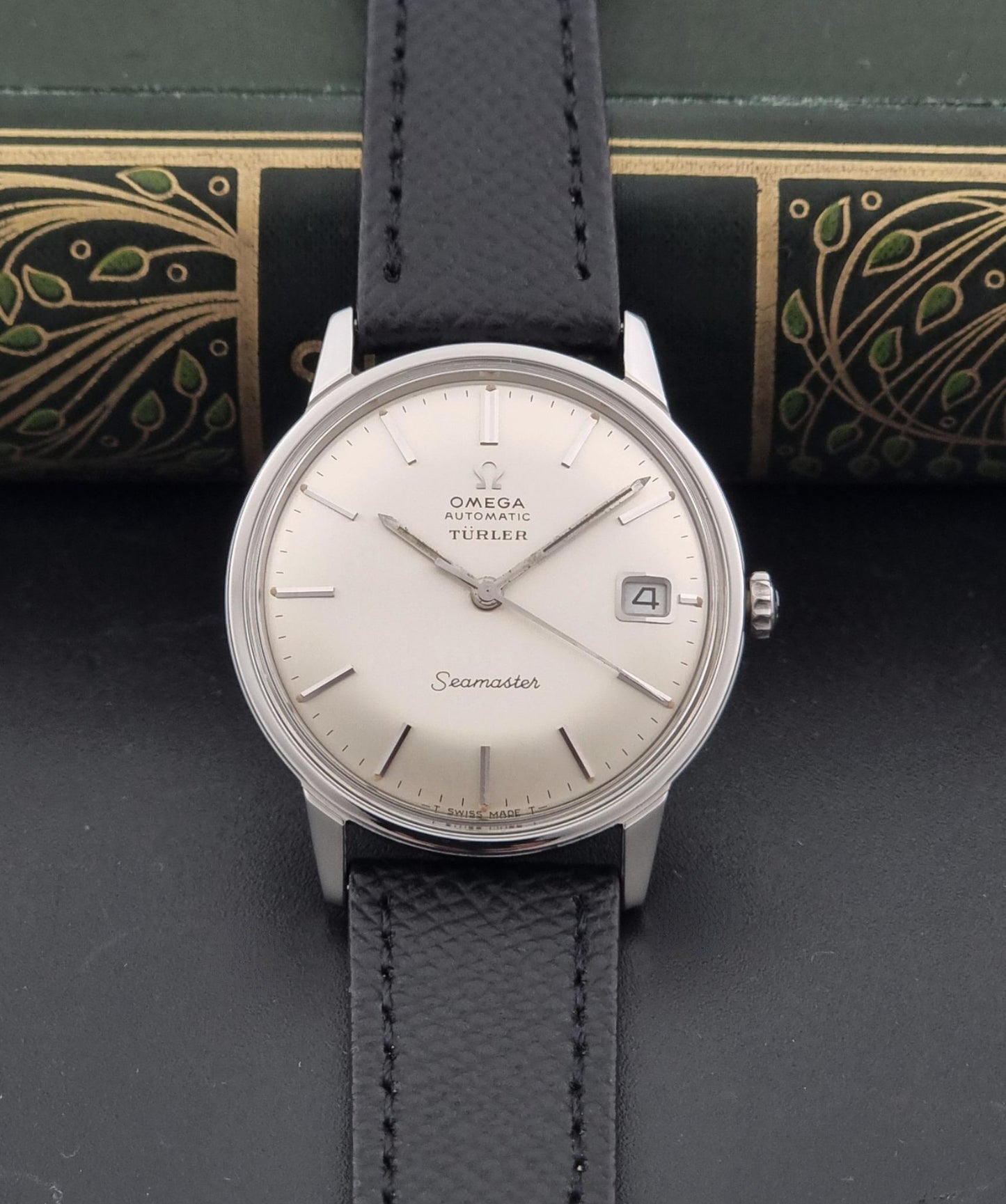 A Vintage Omega Seamaster Wristwatch 166.002 Turler dial on a dark background close up view