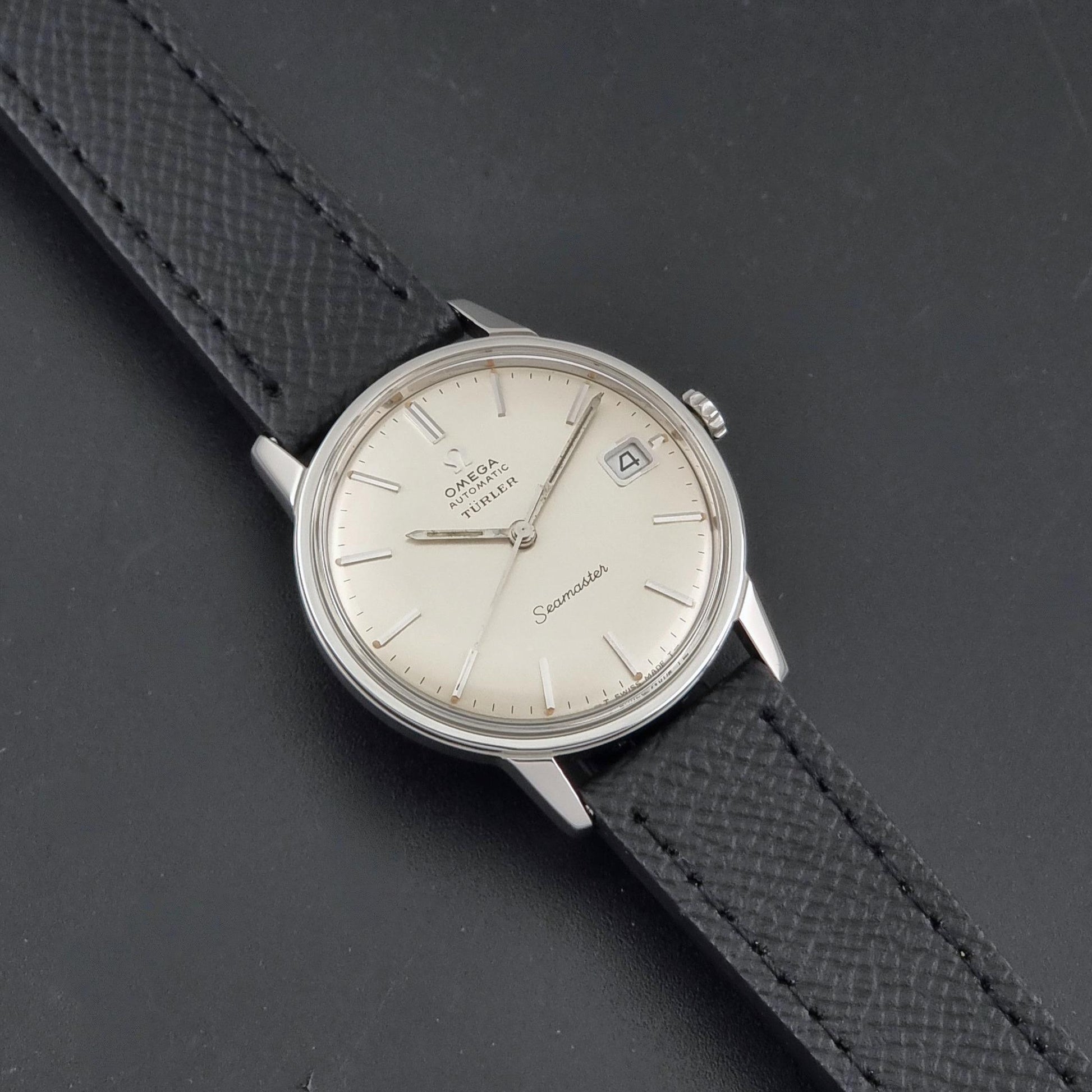 A Vintage Omega Seamaster Wristwatch 166.002 Turler dial on a dark background front view