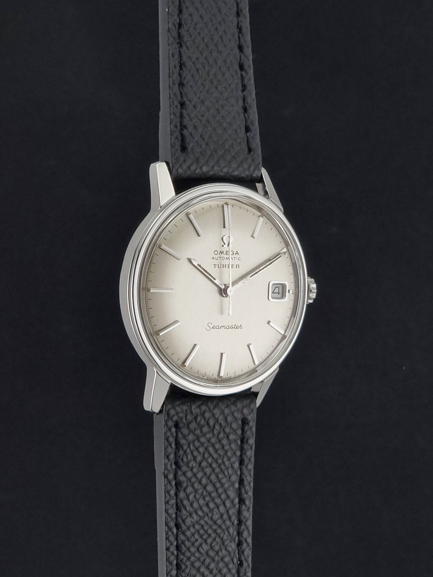 A Vintage Omega Seamaster Wristwatch 166.002 Turler dial on a dark background side profile