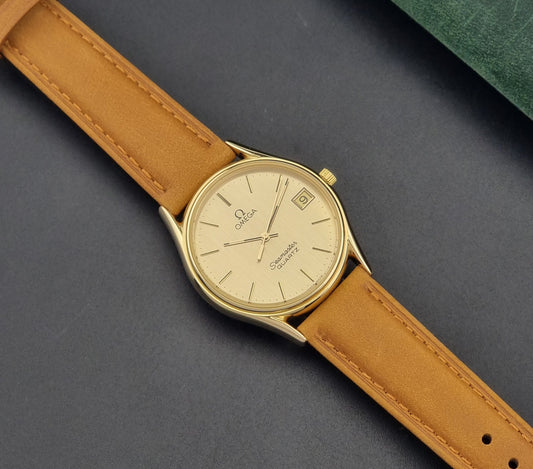  Vintage Omega Quartz Wristwatch Seamaster 196.0281 with a brown leather strap on a dark gray background dial