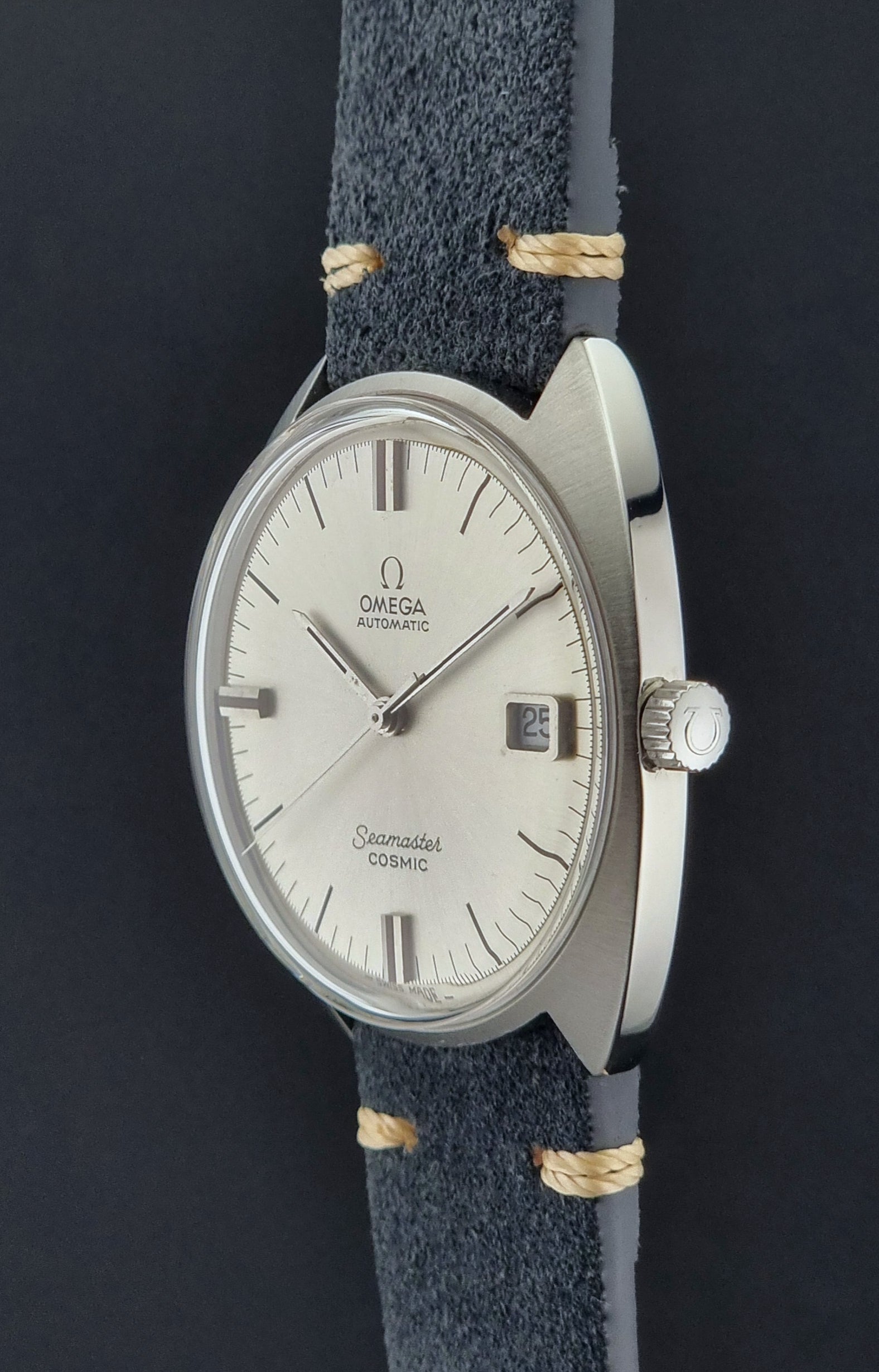 Vintage Omega watch with blue strap on a dark background