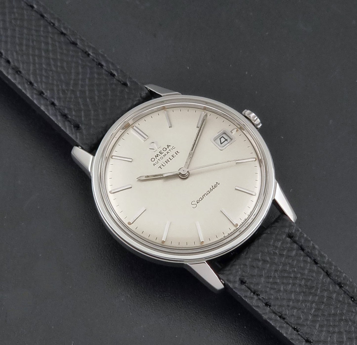 A Vintage Omega Seamaster Wristwatch 166.002 Turler dial on a dark background angled view