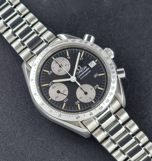 Vintage Omega Speedmaster watch 3511.50  Reverse Panda Date Chronograph with a black face on a dark background